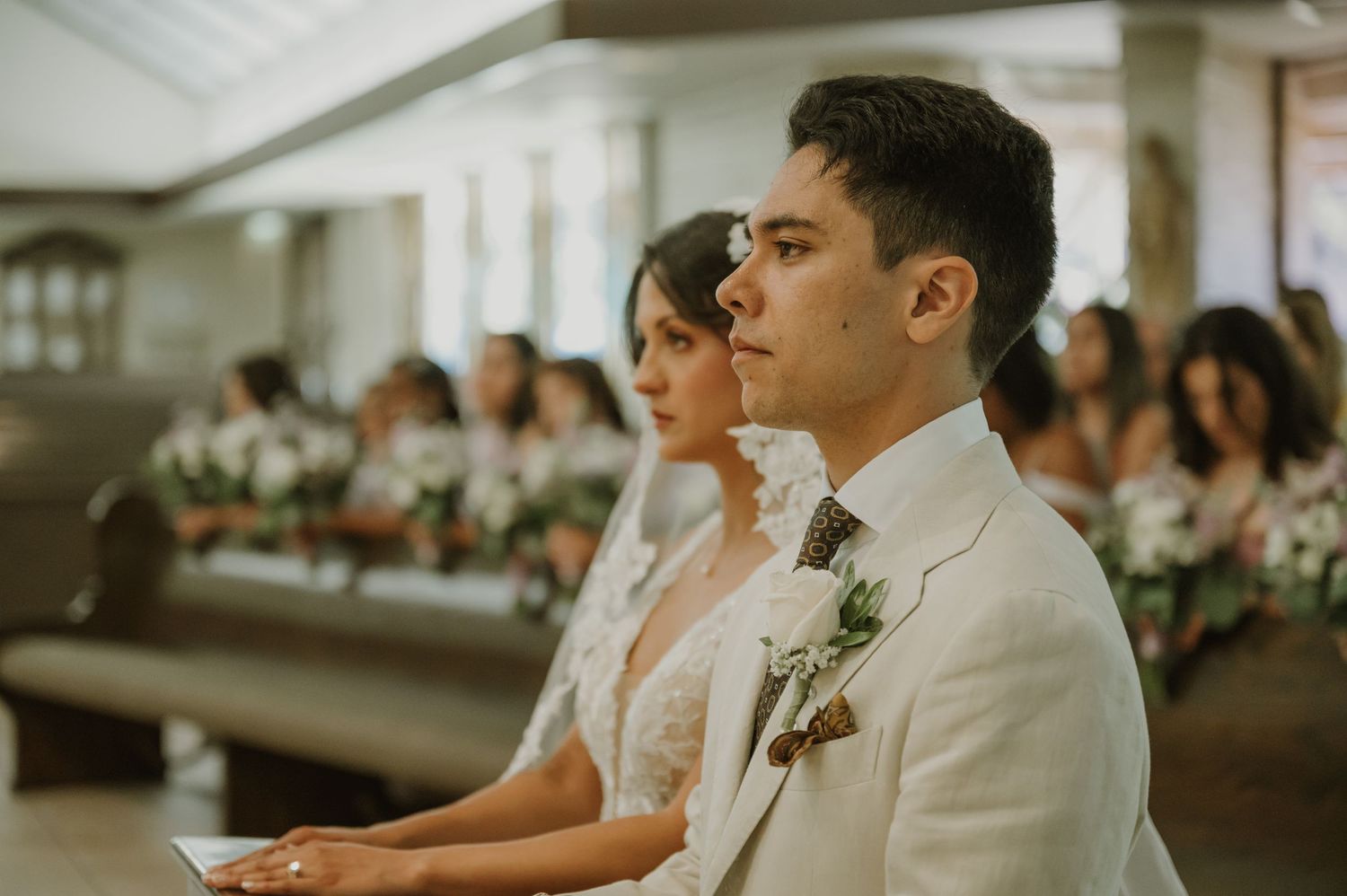Bride and groom stand at the altar during their elegant church wedding ceremony.