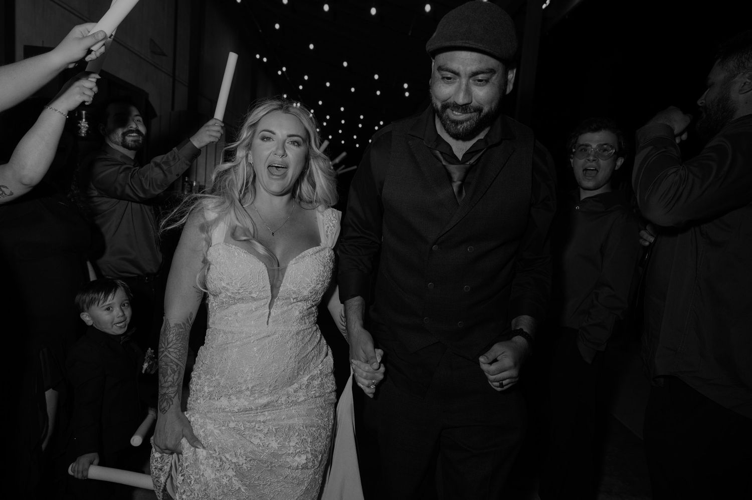Wedding celebration with guests holding sparklers creating a magical nighttime atmosphere.