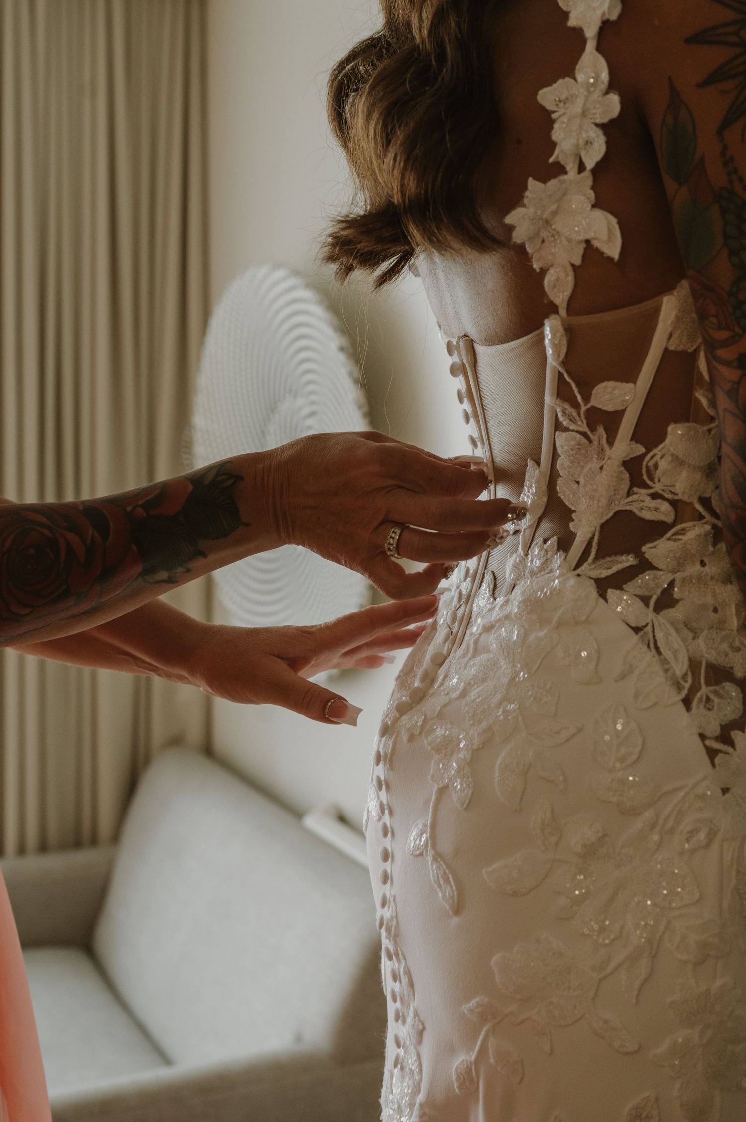 Detail shots highlighting the intricate floral lace patterns on a white wedding gown.