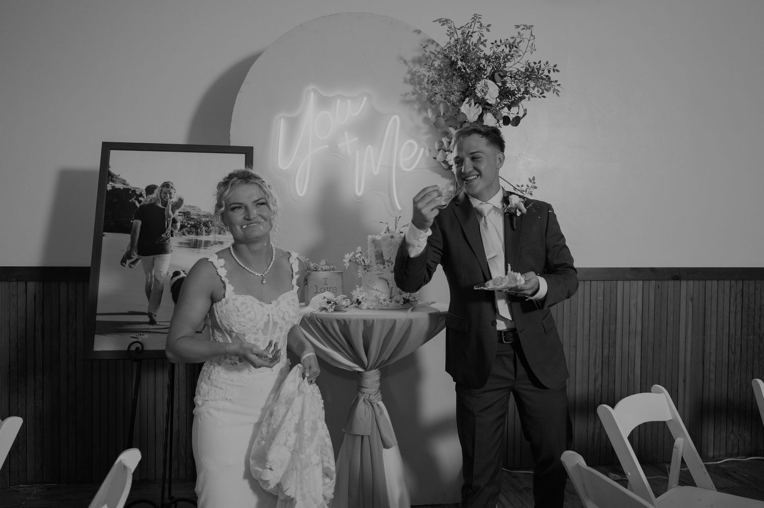 Black and white photo of a couple celebrating during their wedding reception dance.