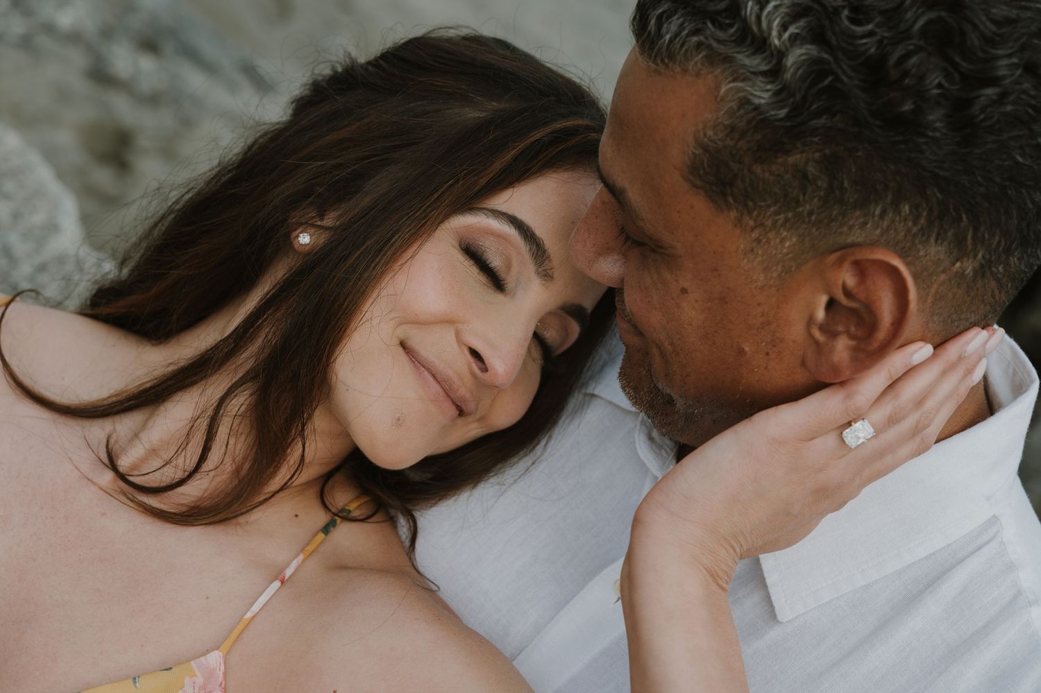 Close-up of an intimate moment between a couple in black and white.