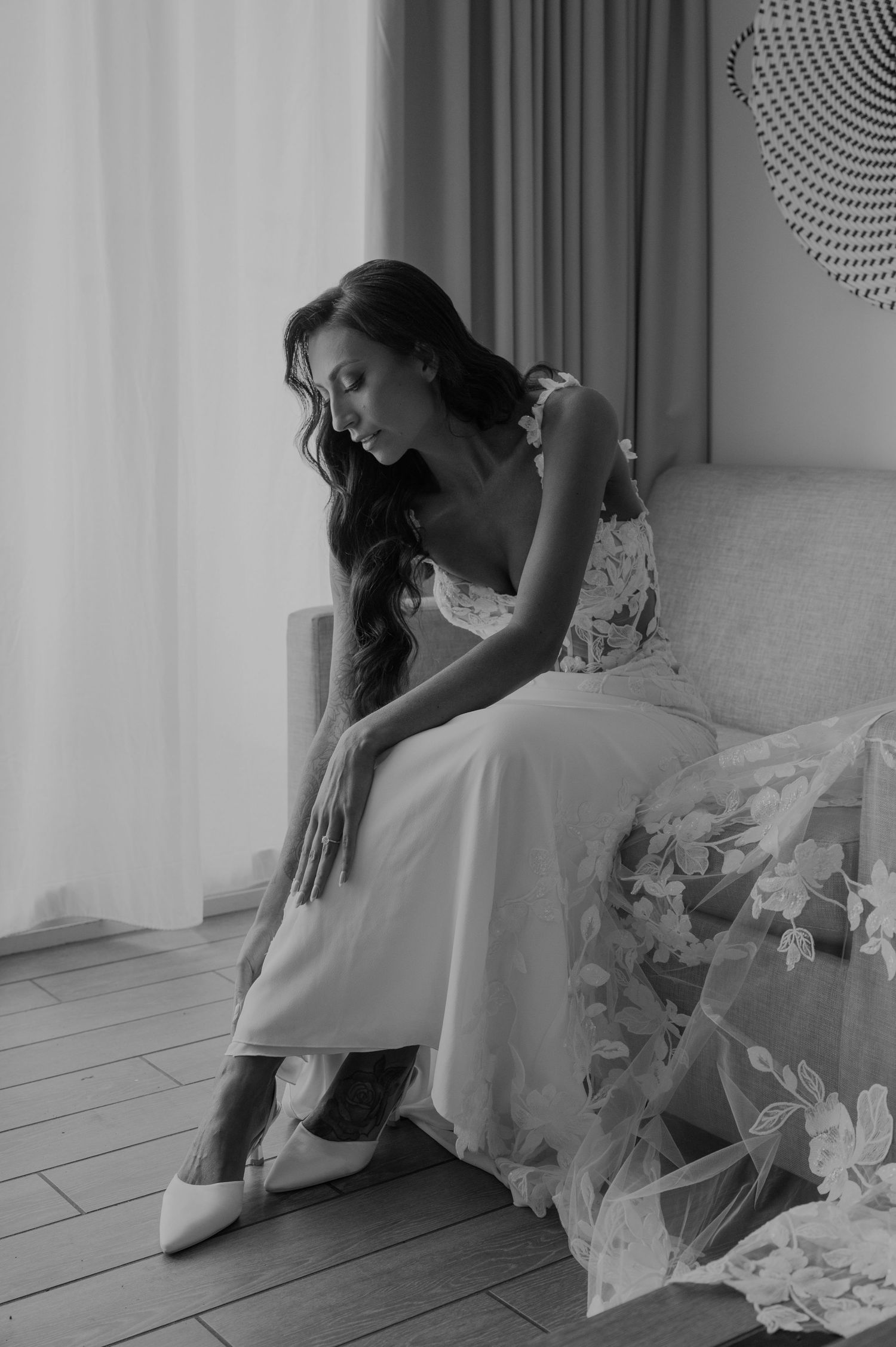 Artistic black and white photograph capturing intimate bridal preparation moments.