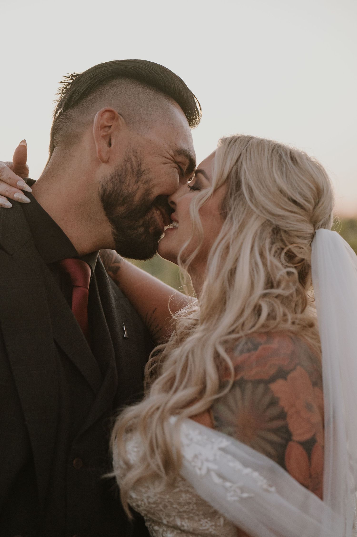 Close-up romantic moment between couple during sunset vineyard photoshoot.