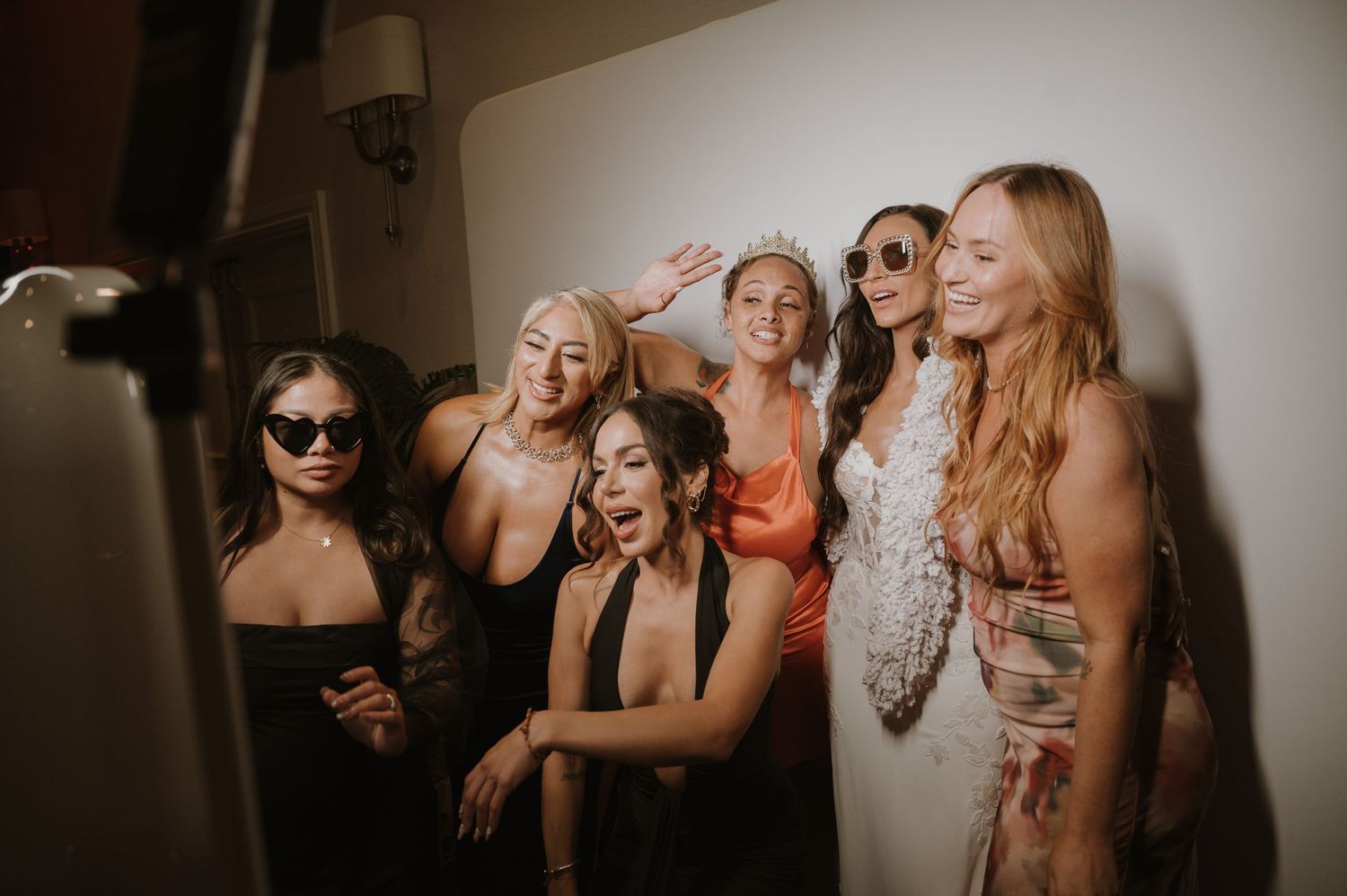 Wedding guests enjoying celebration with stylish sunglasses and festive atmosphere.