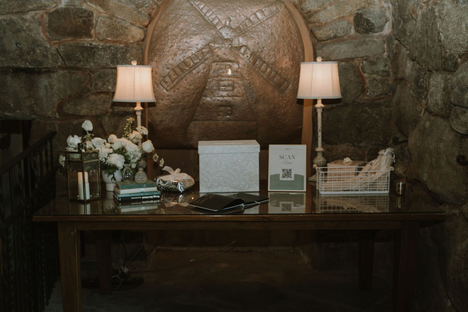 Rustic stone wall interior with decorative lighting and vintage-style wedding decor.
