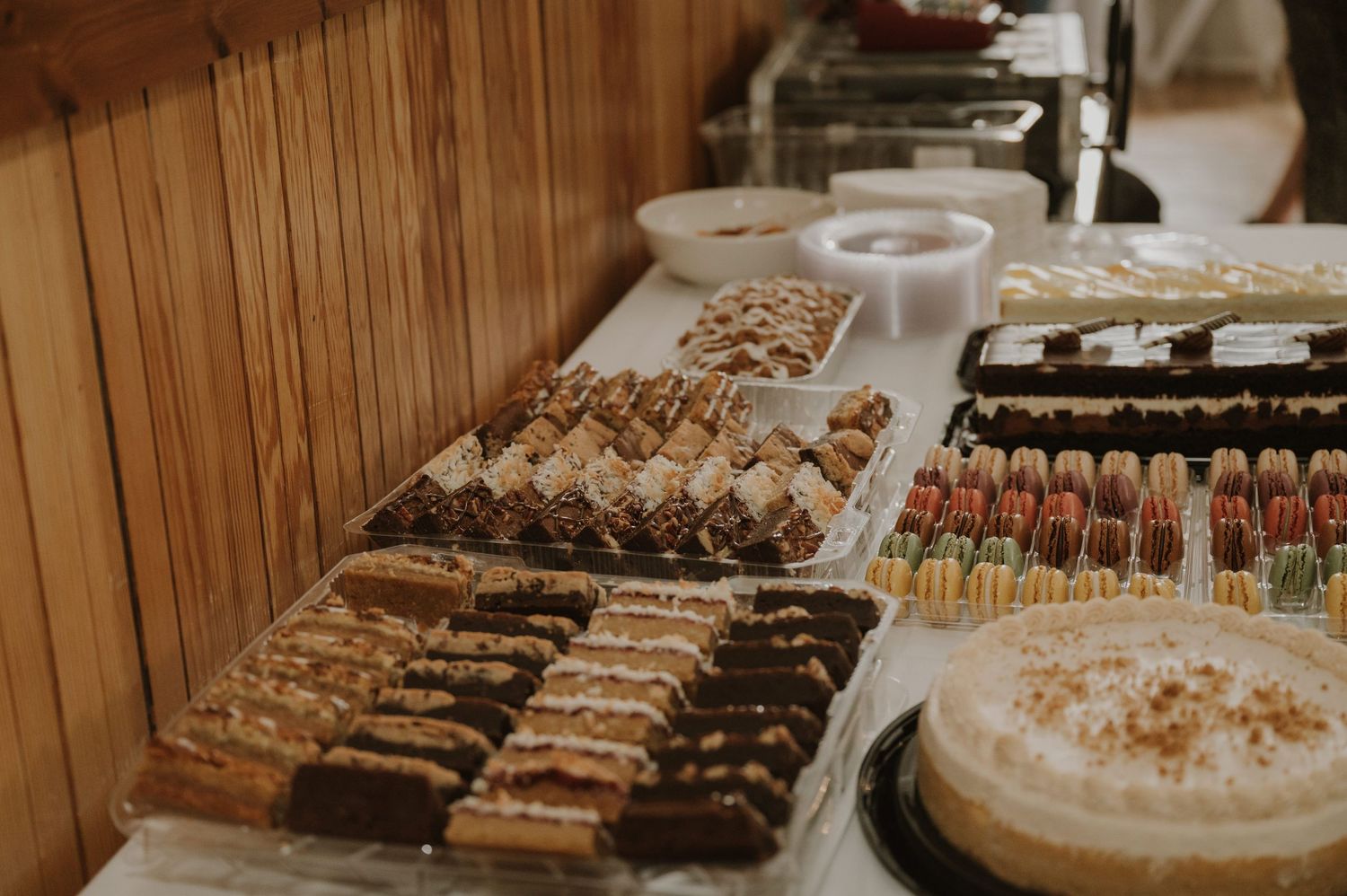 Elegant dessert display featuring various pastries and treats at a wedding reception.
