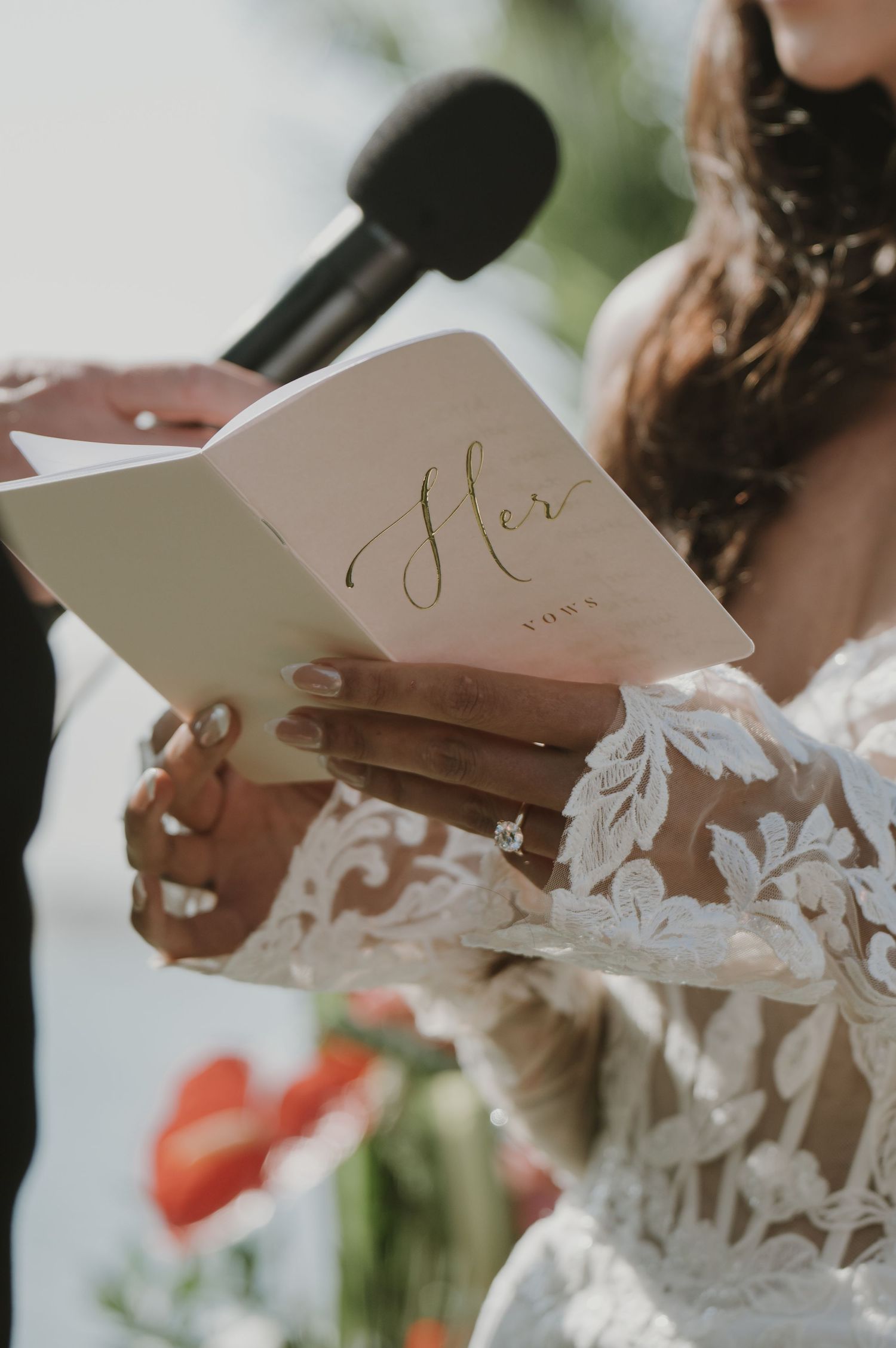 Close-up shots of wedding invitation cards with delicate white floral details.