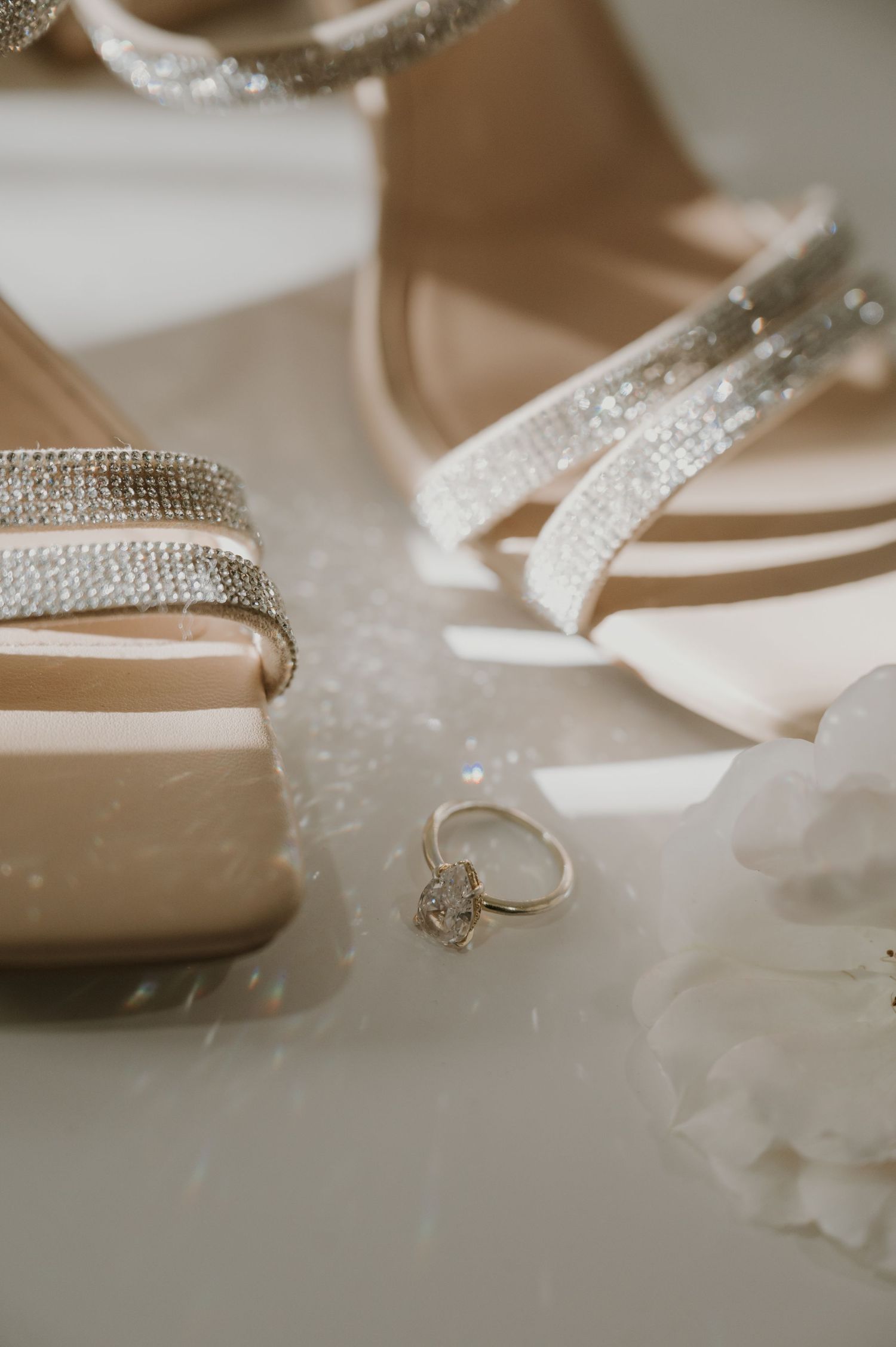 Close-up of sparkly bridal shoes with rhinestone details and delicate embellishments.