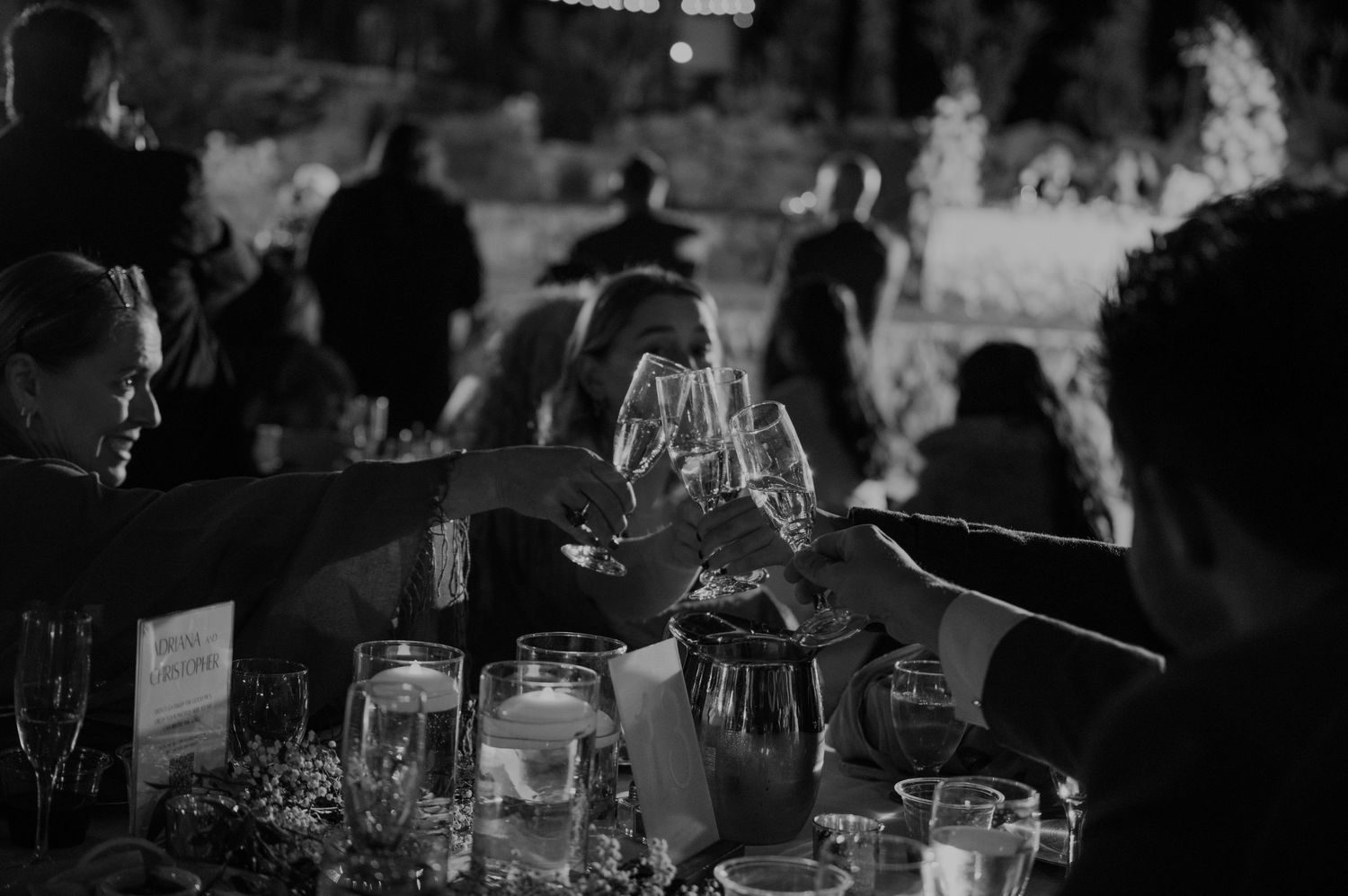 Candlelit wedding reception with guests enjoying evening celebrations.