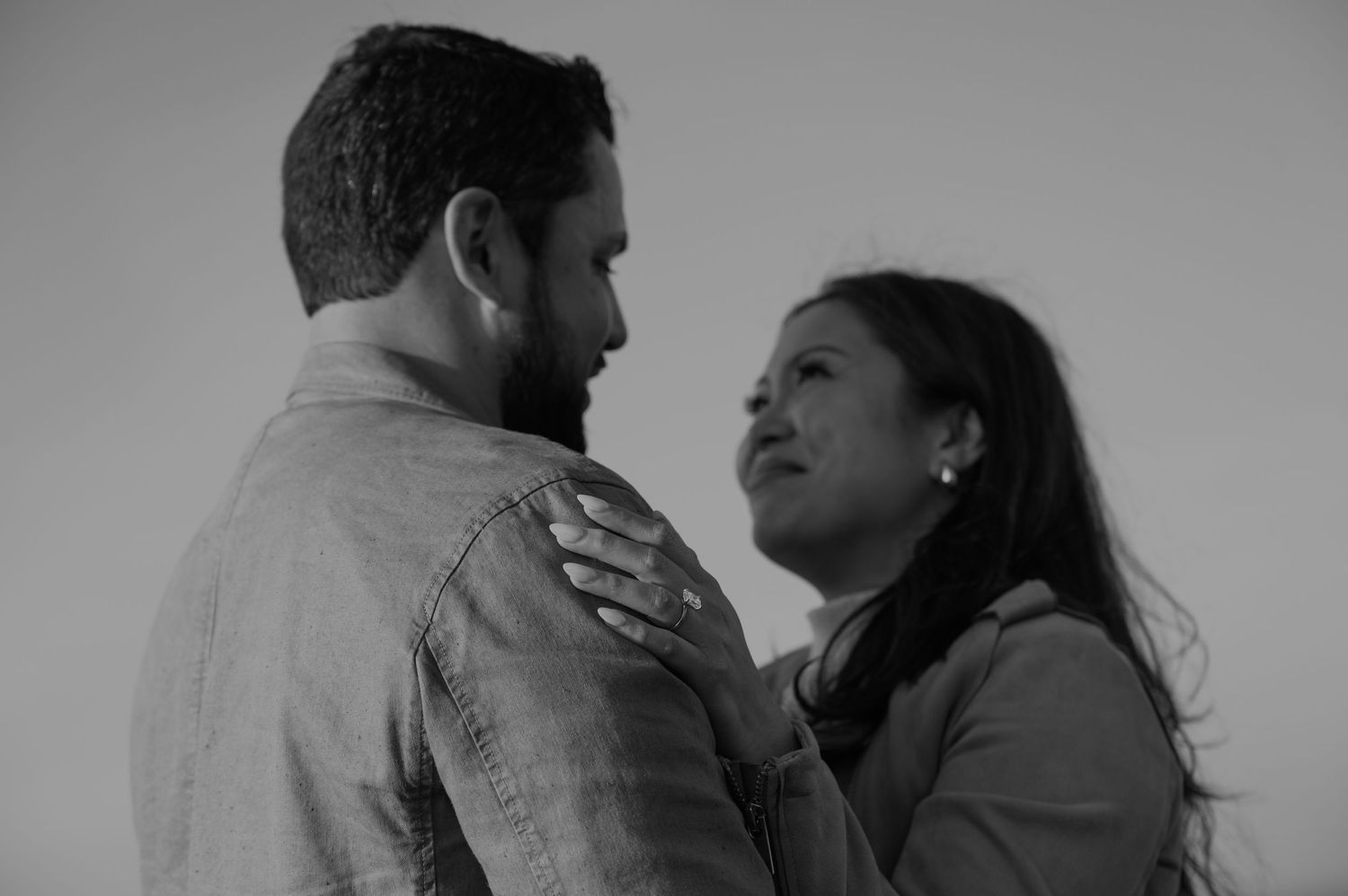 Black and white series of a couple embracing and showing tender moments together.