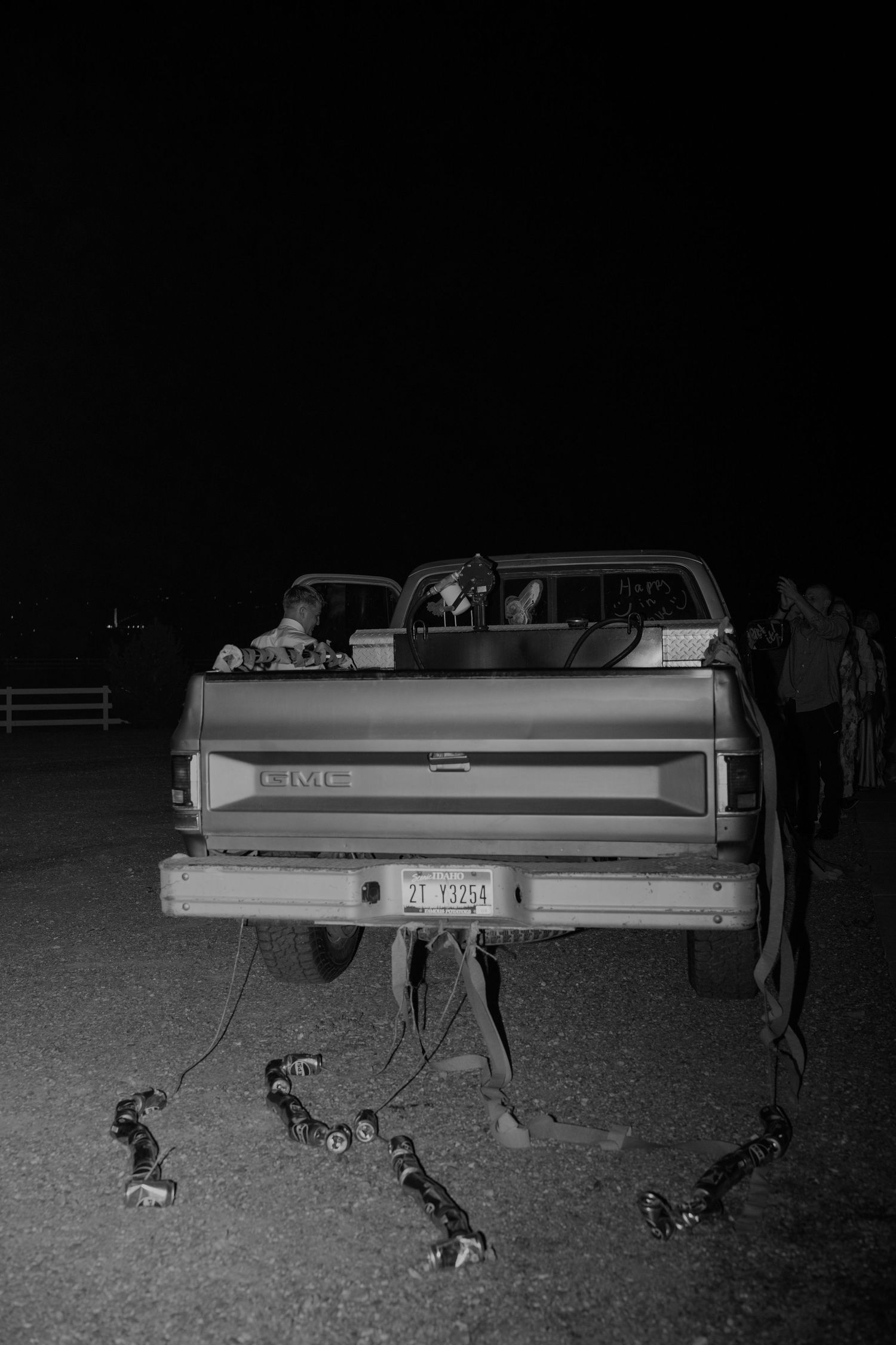 Vintage GMC pickup truck parked in a field at night during a wedding celebration.