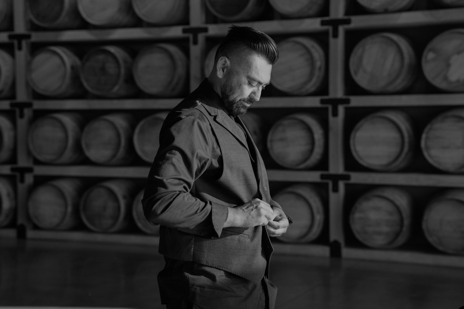 Dark atmospheric shots of wooden barrels in a rustic cellar setting.