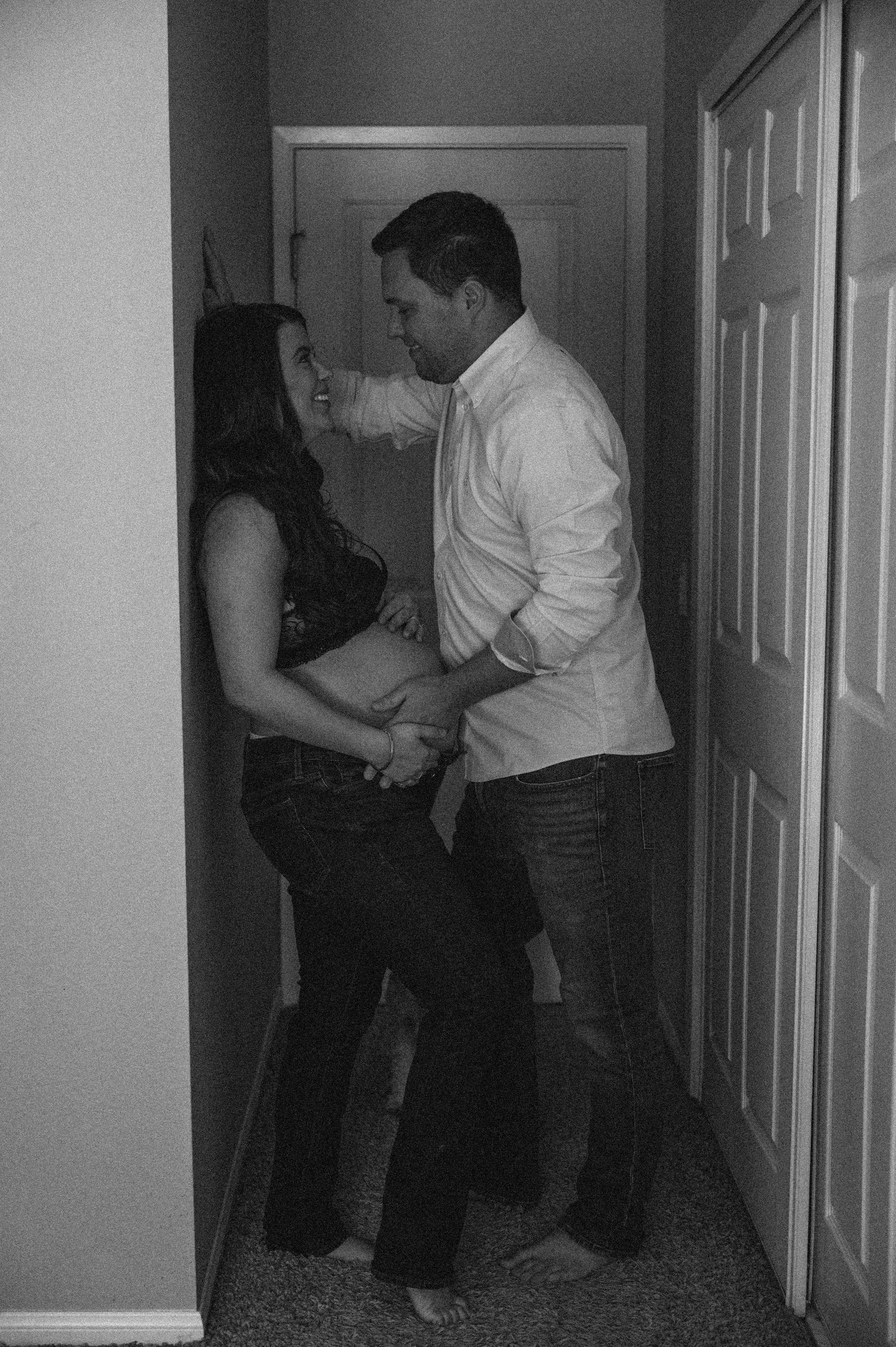 Two figures dance together in a dimly lit hallway.