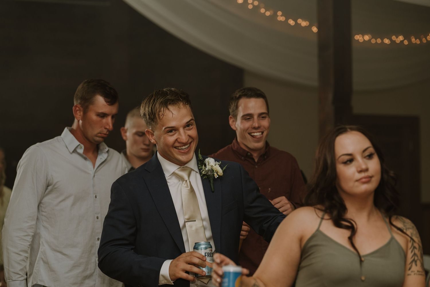 Wedding guests enjoy dancing and socializing during evening reception celebration.