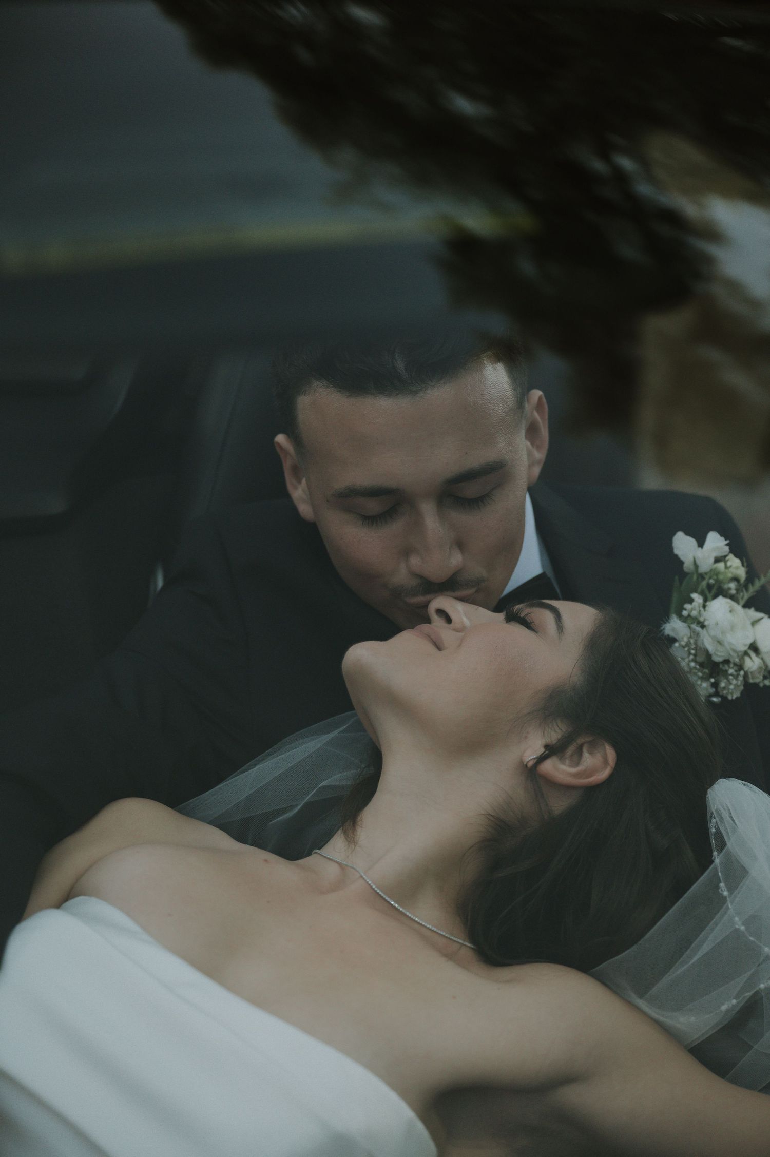 An intimate romantic moment captured between a couple in wedding attire.