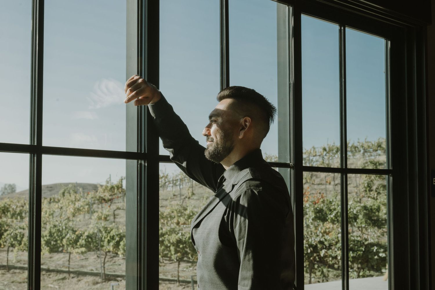 Modern venue interior with floor-to-ceiling windows overlooking natural landscape.