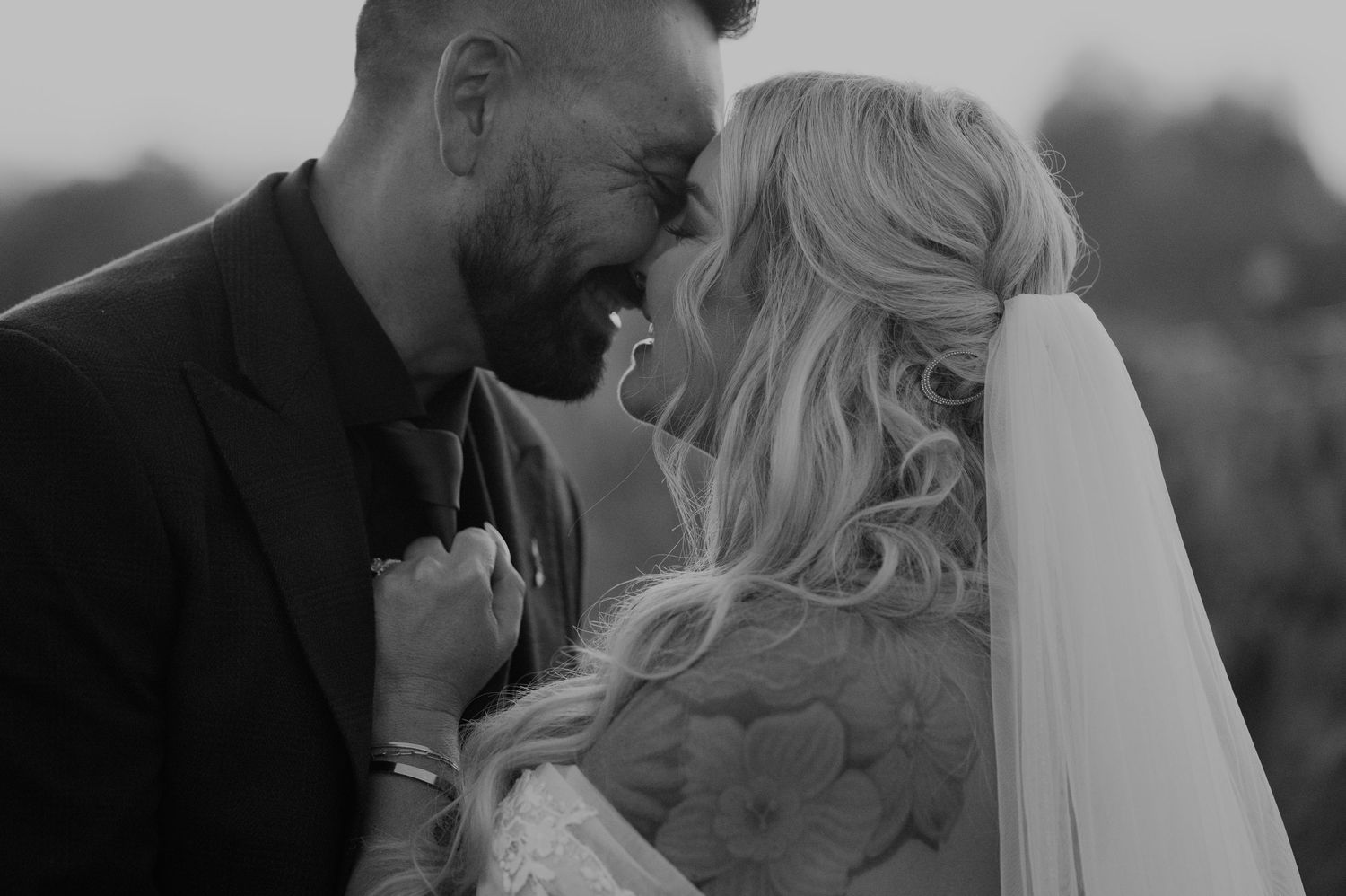 A series of black and white romantic wedding portraits showing tender moments between newlyweds.