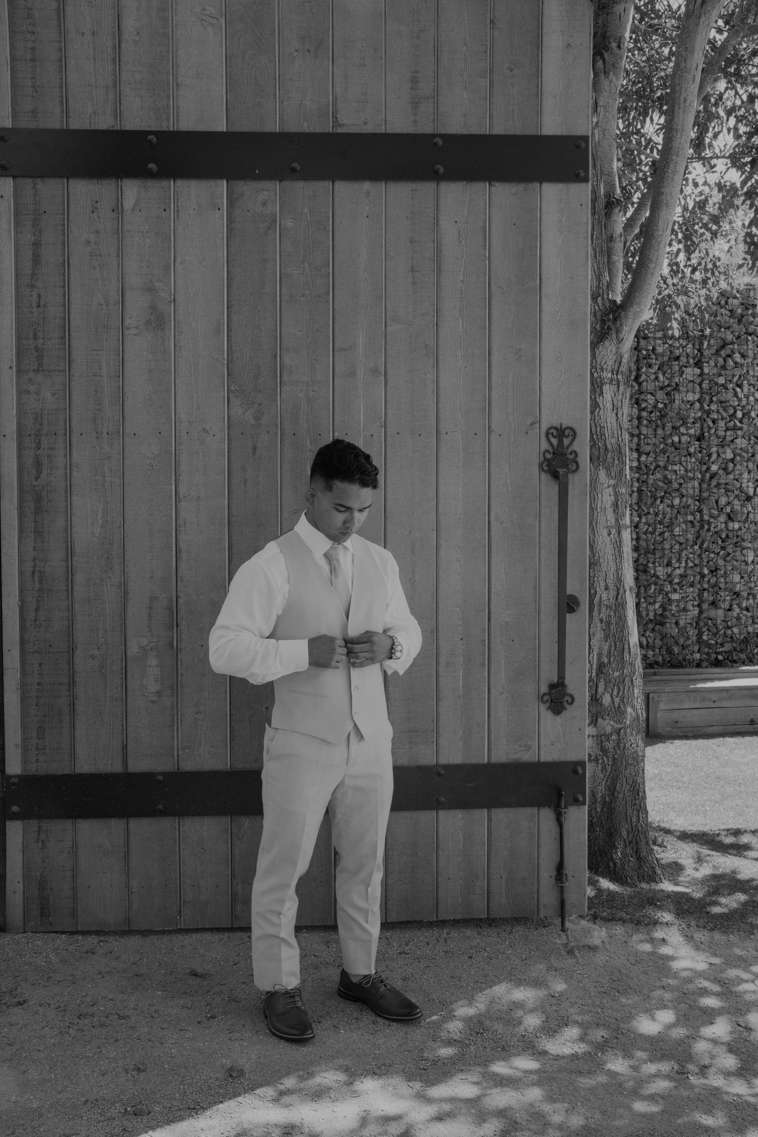 Series of black and white photos showing someone in white attire against a wooden backdrop.