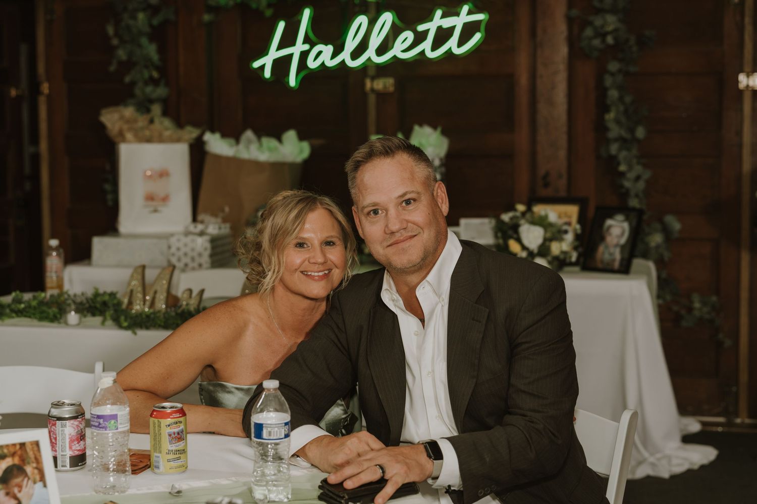 Custom neon name sign illuminates the wedding reception space.