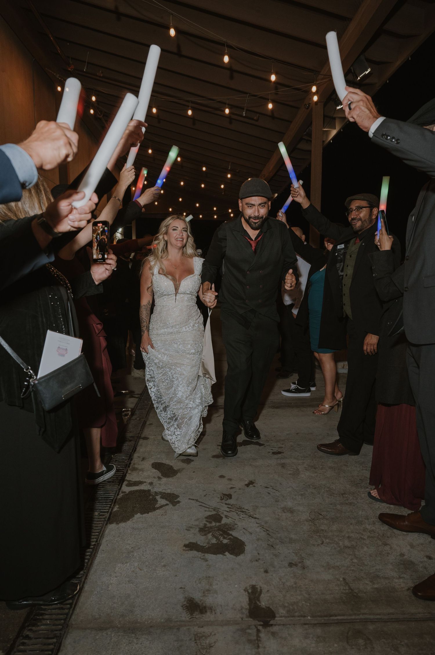 Wedding guests celebrate with sparklers during an evening reception creating a magical light display.