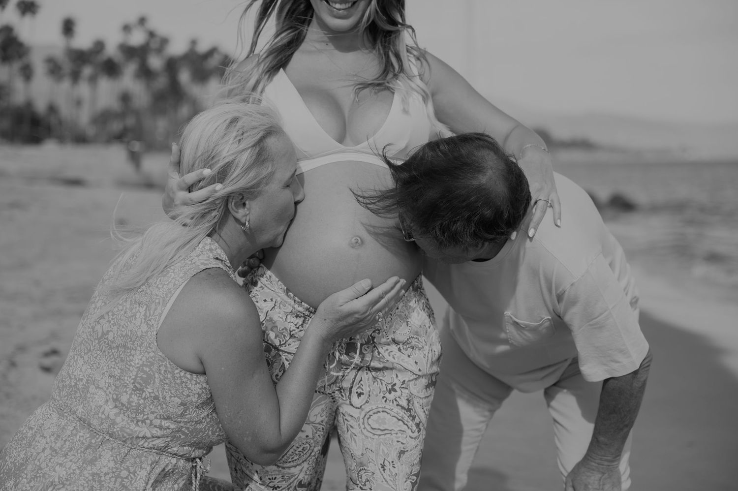 A joyful moment captured at the beach with white attire and natural lighting.