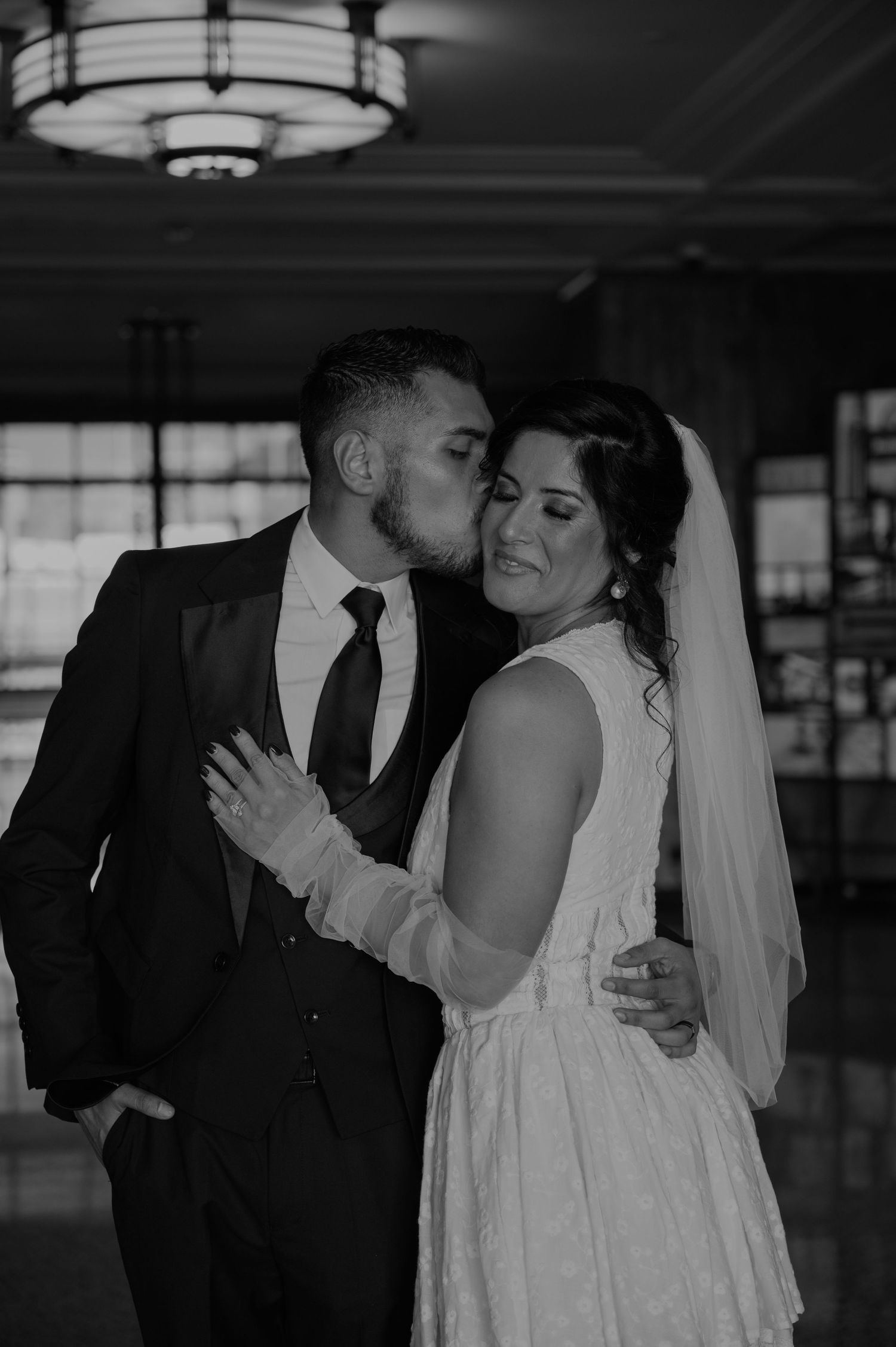Black and white romantic wedding photos capture intimate moments between newlyweds.