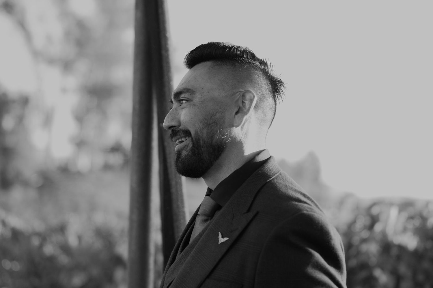 Black and white portrait in dramatic lighting at an outdoor event.
