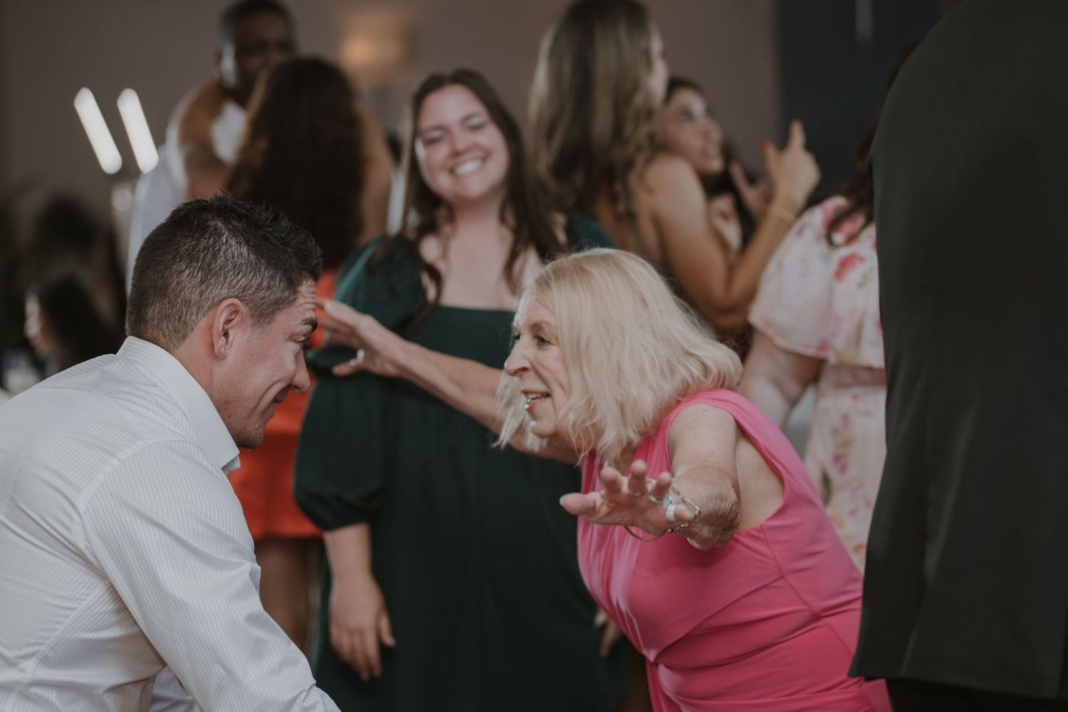 Wedding reception guests enjoying intimate moments on the dance floor.