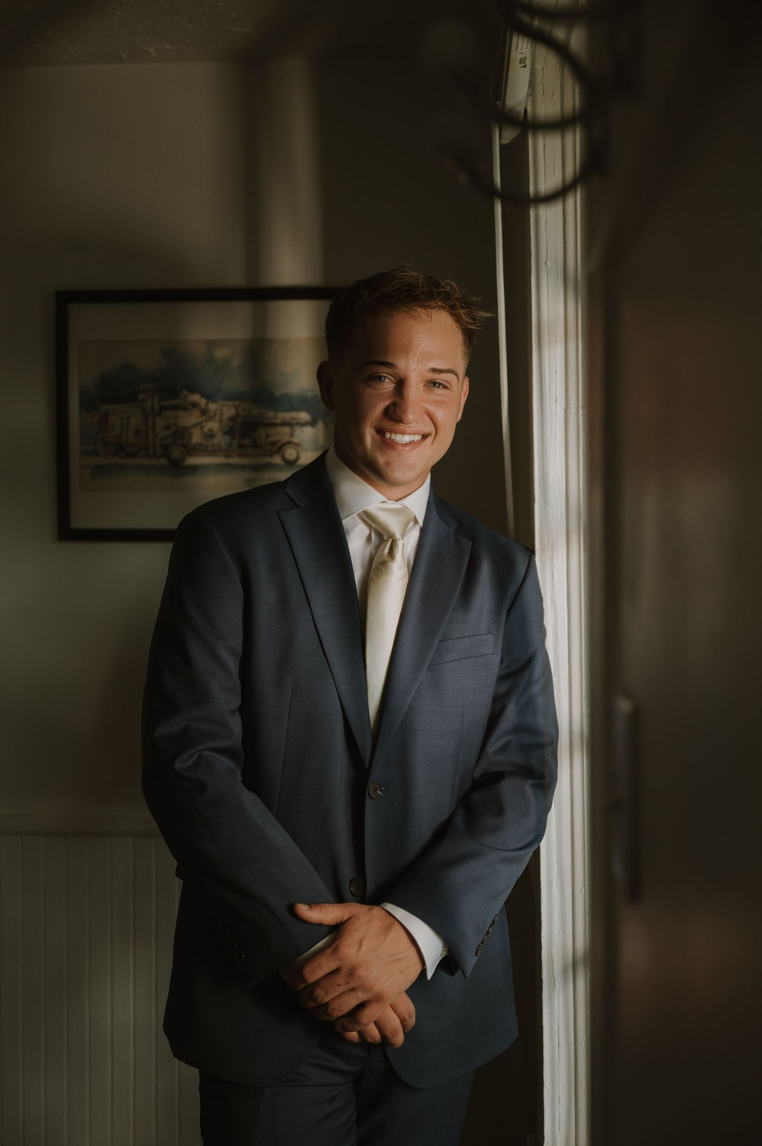 Atmospheric portraits taken in an indoor setting with natural window light.
