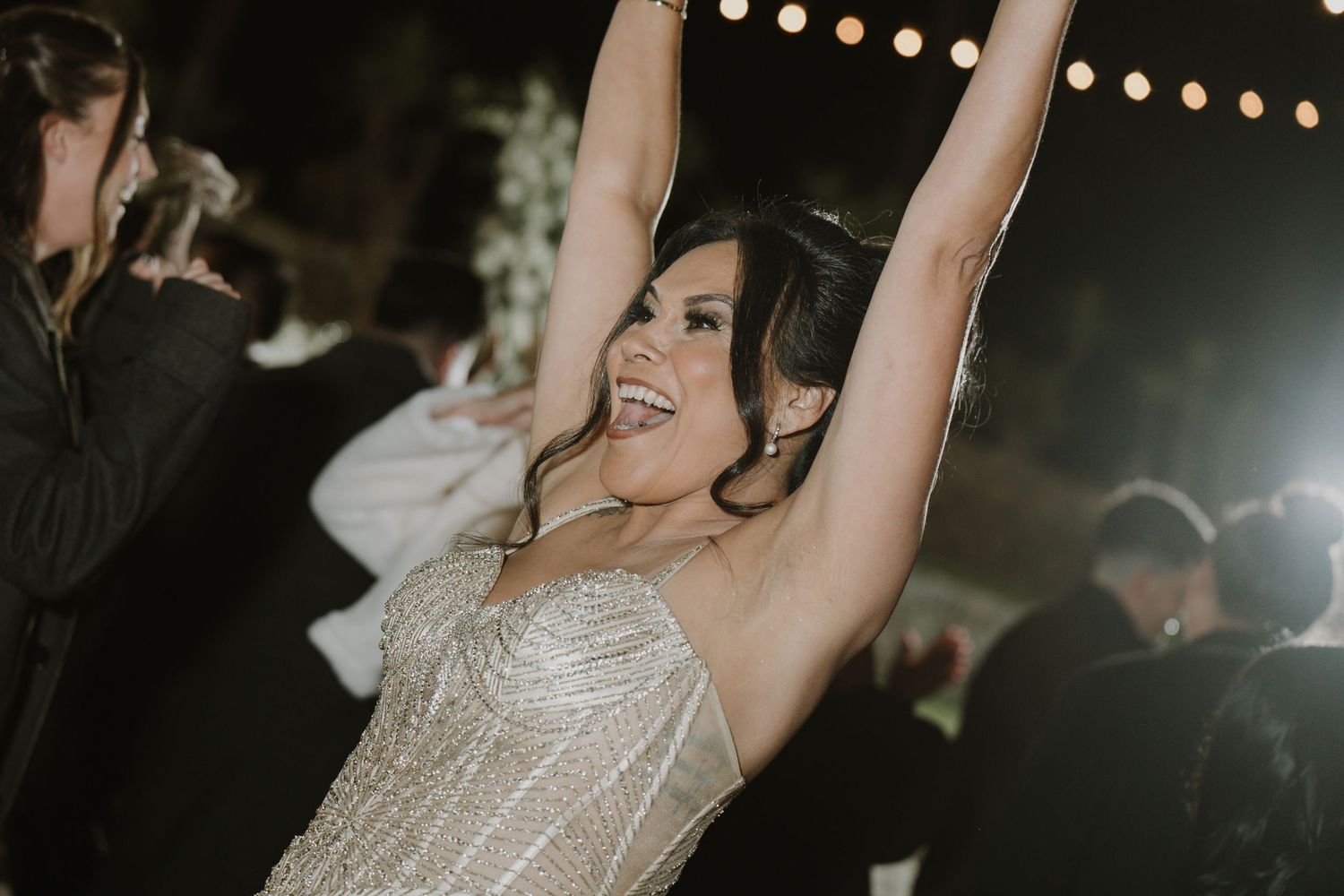 Wedding reception dance party with string lights creating a festive atmosphere.