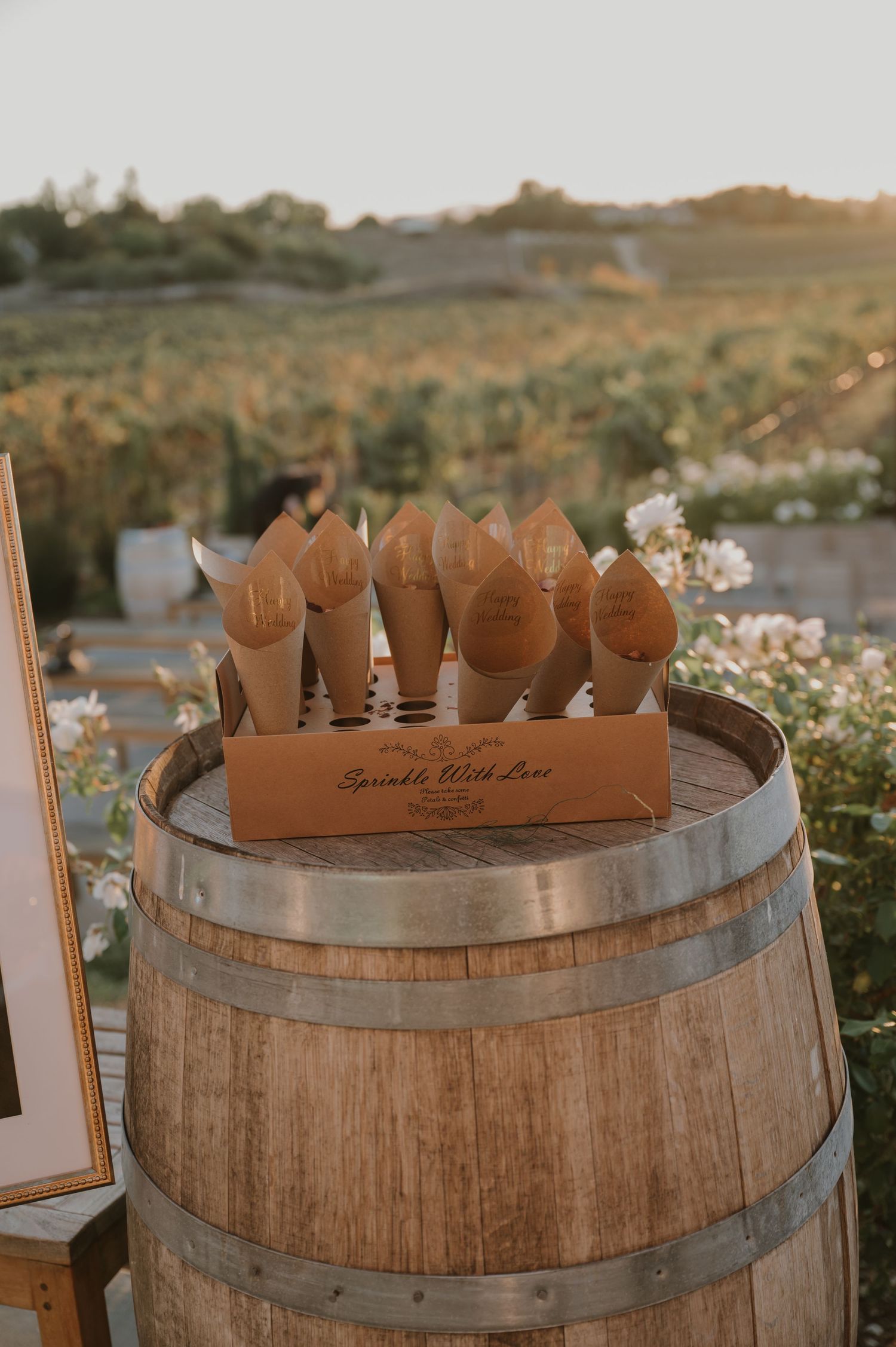 Decorative wooden wine barrel top with rustic lettering displayed outdoors at sunset.