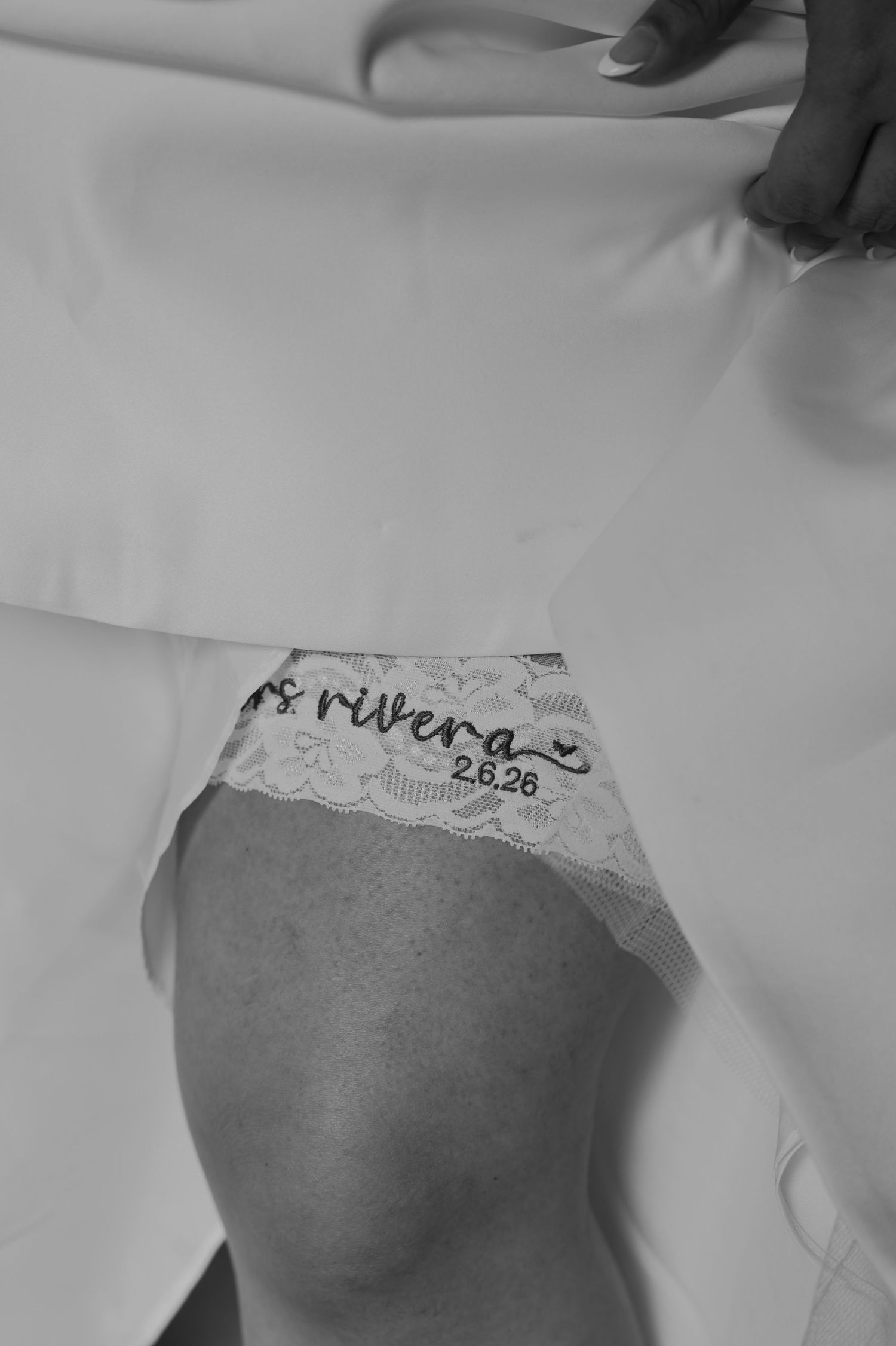 Black and white photo of bride wearing custom Mrs. Rivera 2.6.26 lace wedding lingerie.