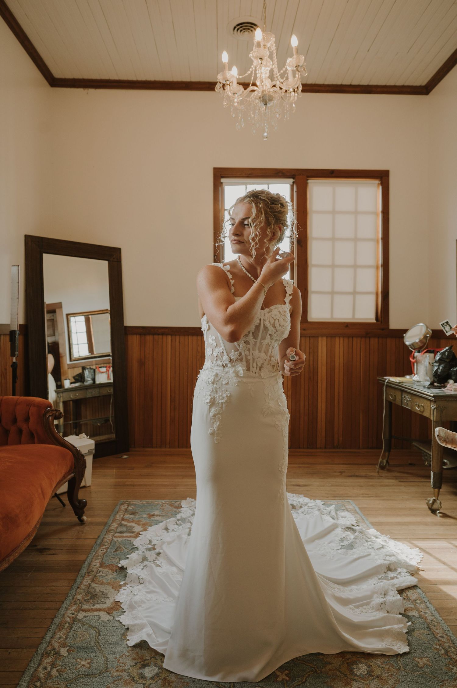 A bride twirls in an elegant white wedding gown with a flowing train.