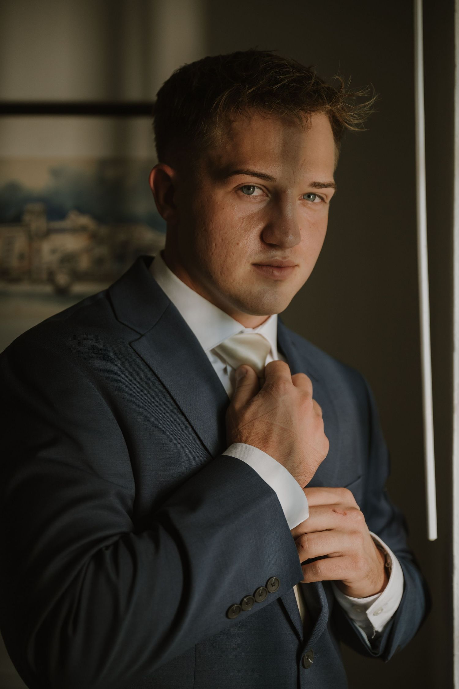 Moody portrait series focusing on formal attire details in warm lighting.