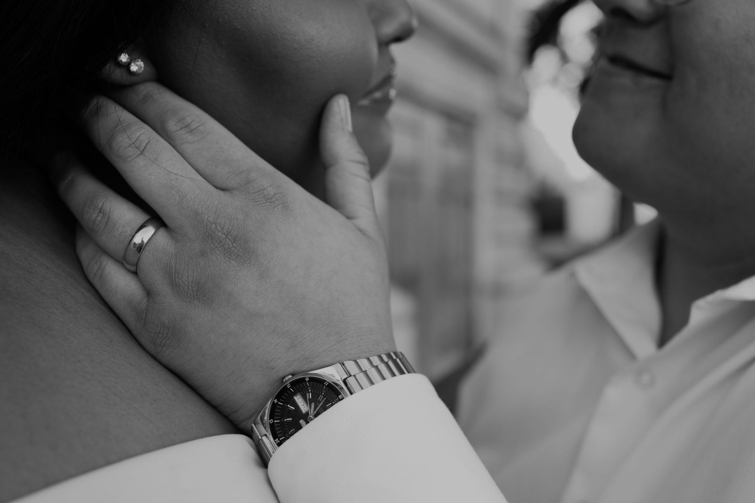 Black and white close-up shots of hands and rings during an intimate moment.