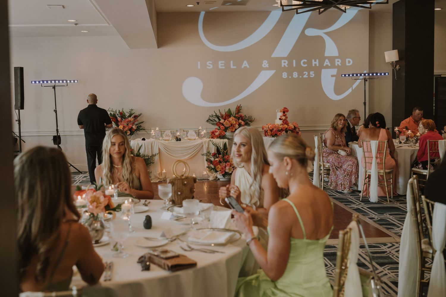 Wedding reception venue with elegant table settings and floral decorations.