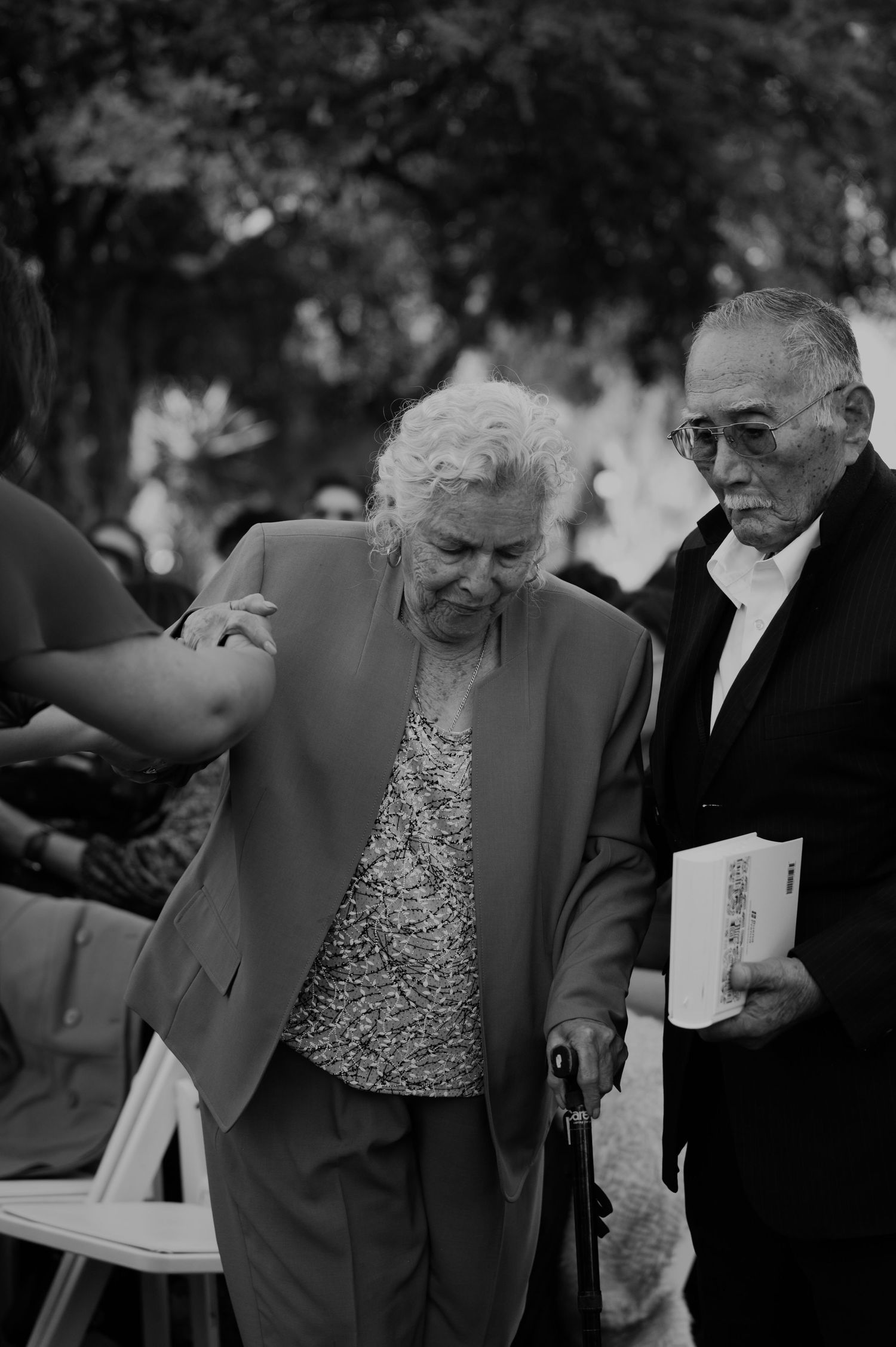 Outdoor gathering with people interacting in black and white photography.