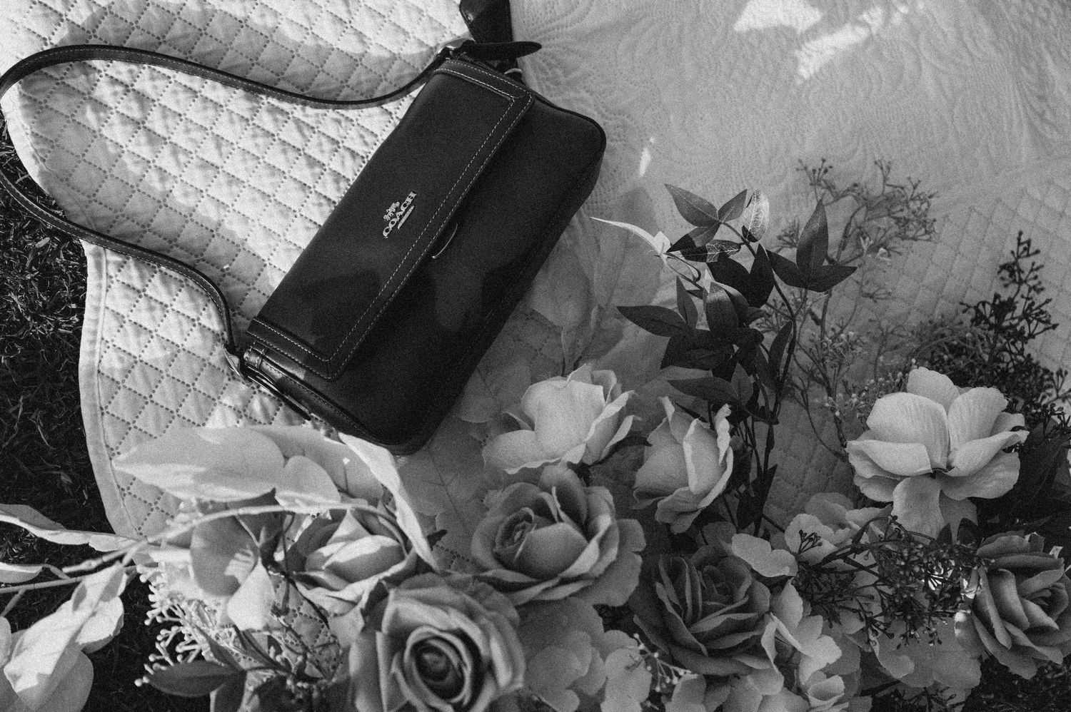 Wedding floral arrangement in black and white featuring roses and delicate blooms.