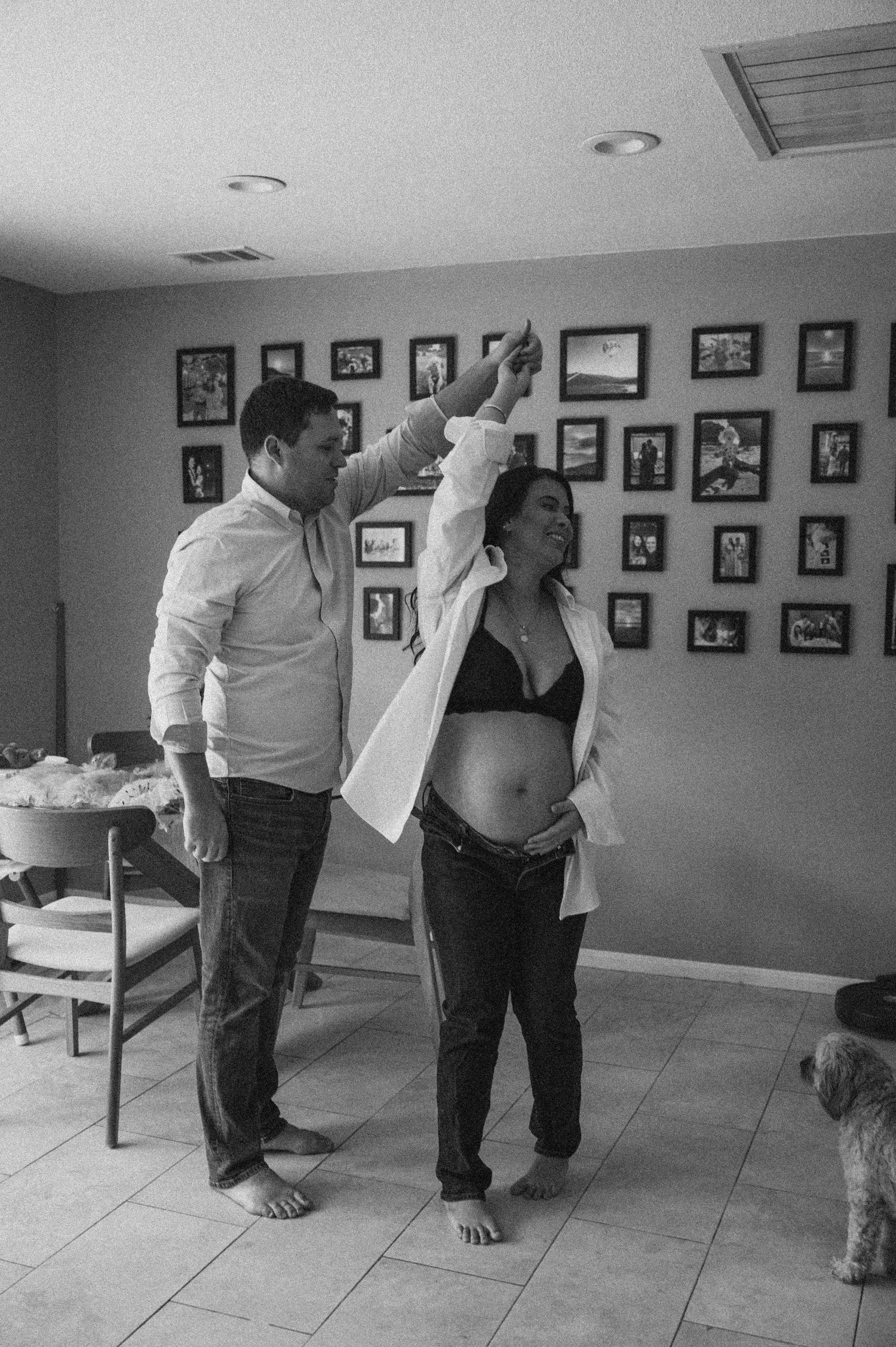 Series of black and white photos showing preparations in a room with framed photos on the wall.