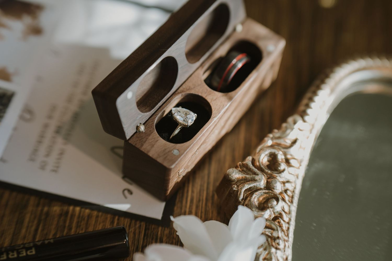 Wooden blocks and delicate lace details create an artistic wedding day flatlay composition.