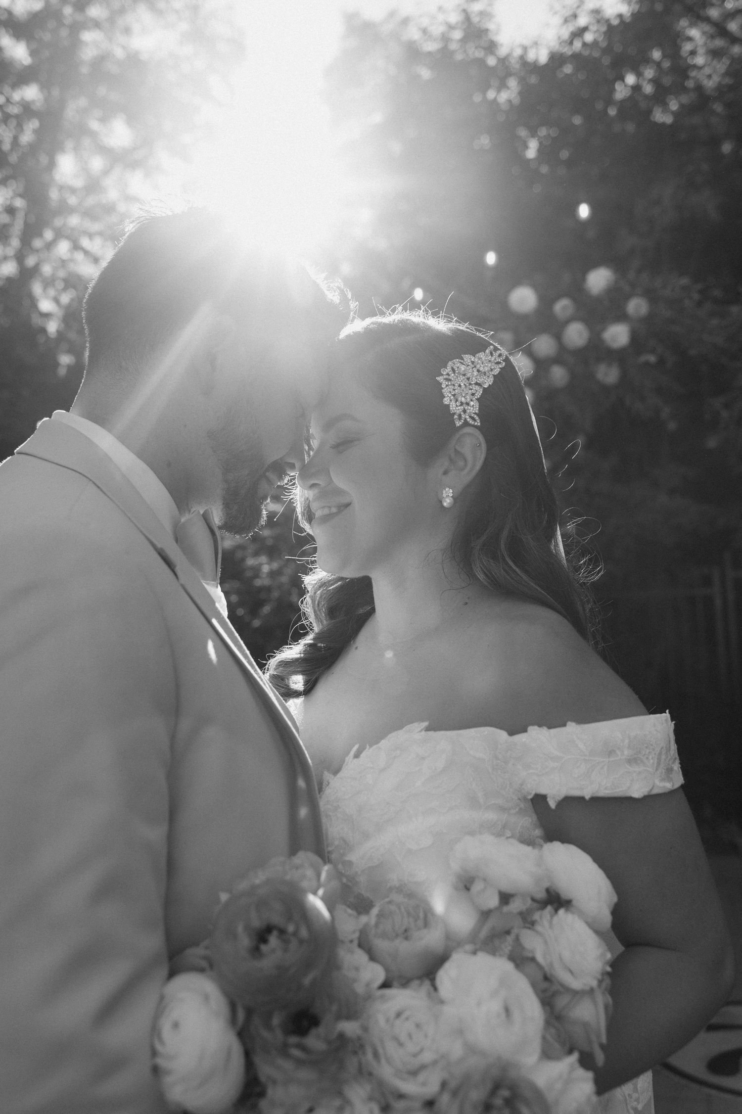 Romantic sunlit wedding portraits captured in dreamy black and white.
