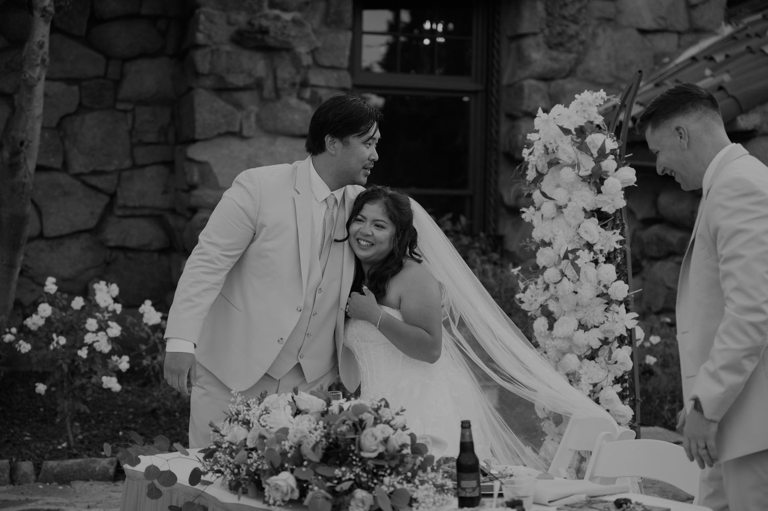 Bride and groom share a tender moment at the altar during their outdoor wedding ceremony.