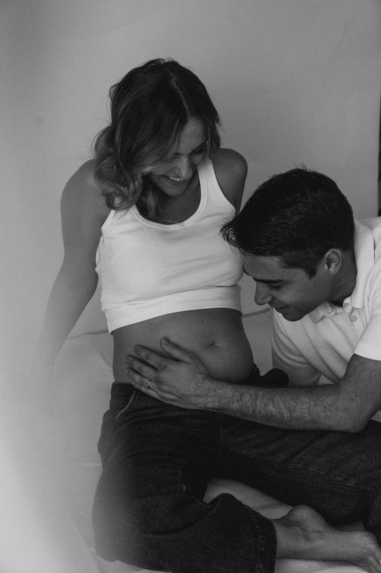Black and white intimate maternity photo session indoors.