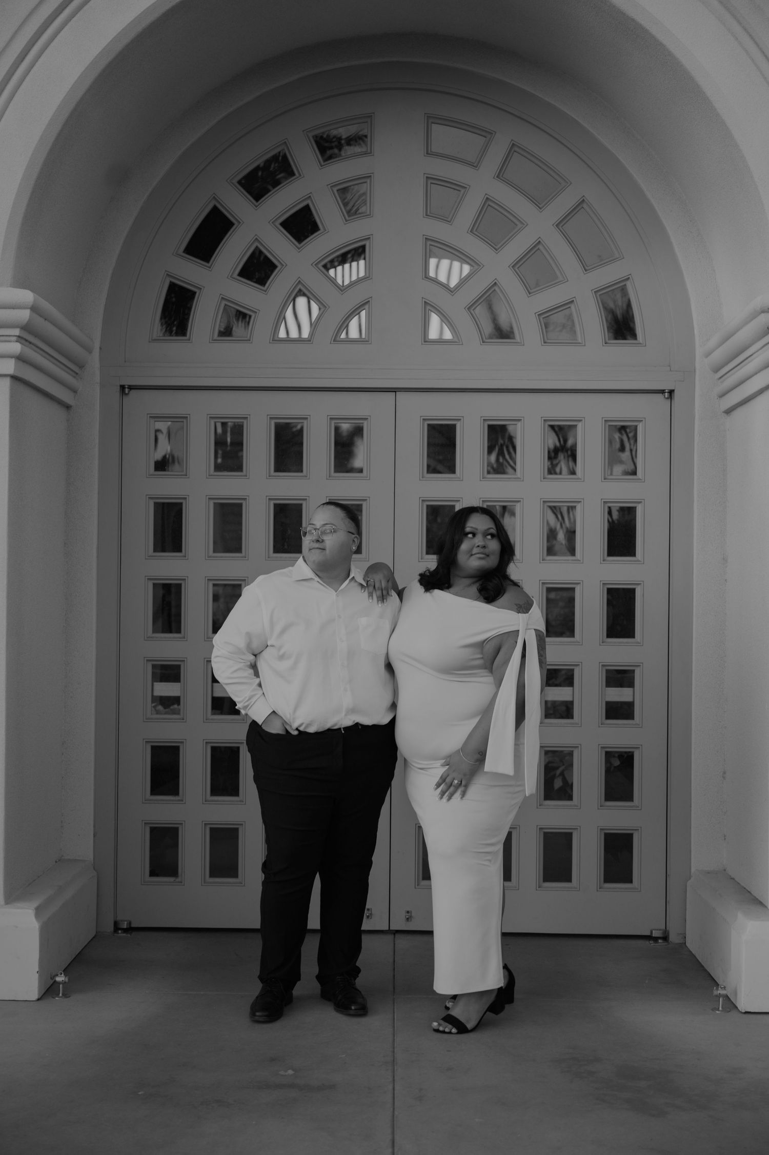Elegant white arched hallway with decorative windows and architectural details.