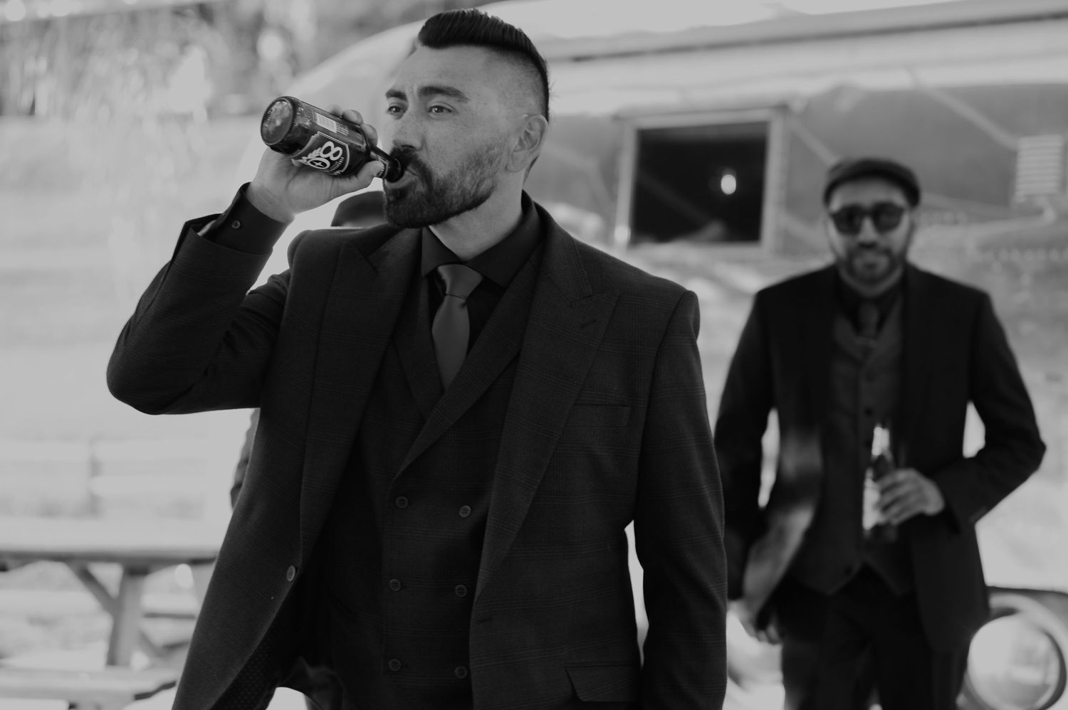 Black and white sequence showing people in formal attire moving through a space.