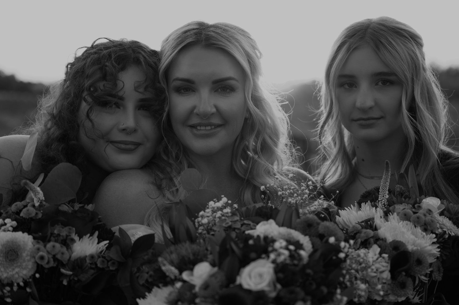 Wedding party poses together in black and white at a scenic outdoor venue.