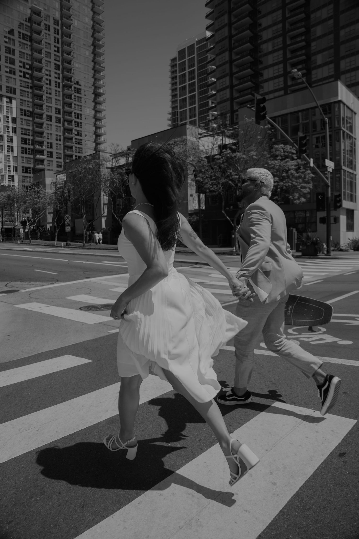 Playful couple having fun on a crosswalk in an urban setting.