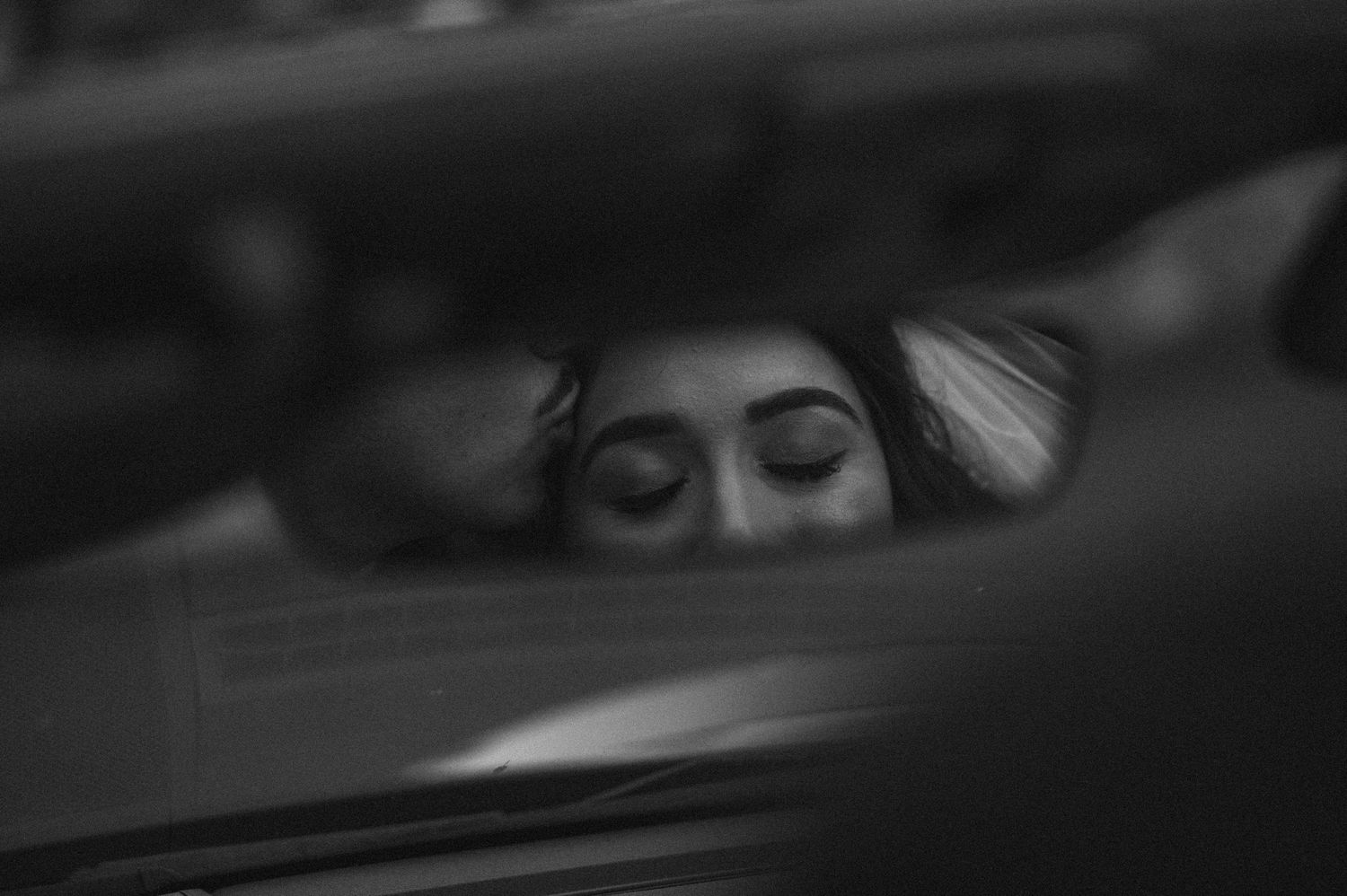 An artistic black and white reflection shot through a car mirror.