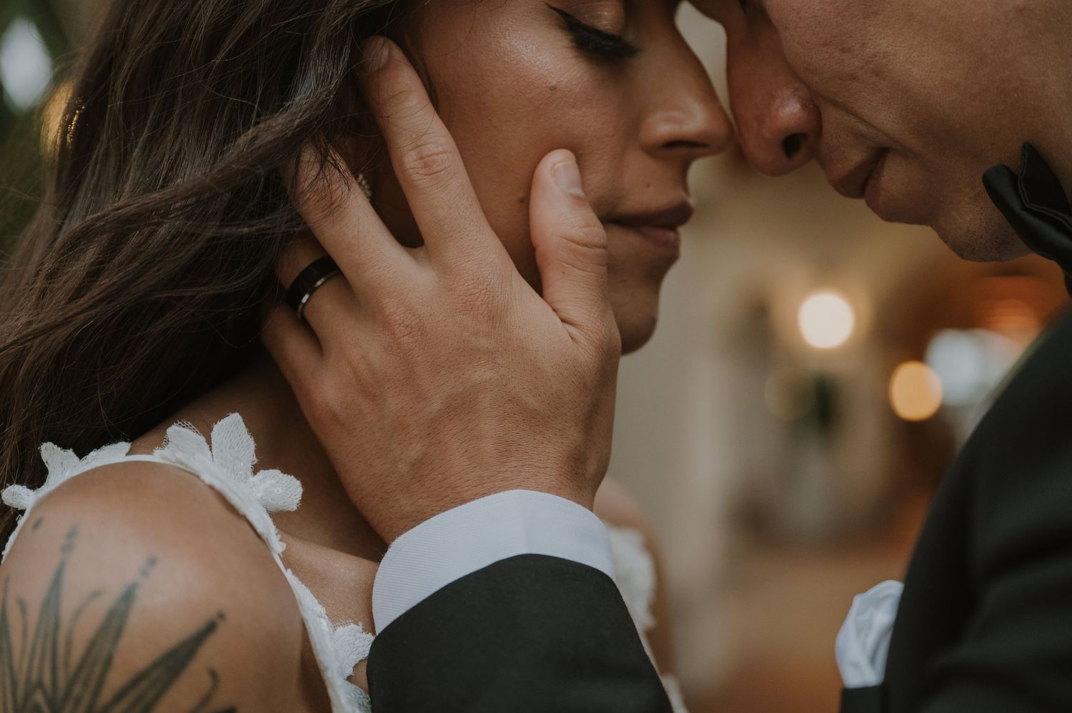 An intimate close-up of a couple sharing a romantic moment during their wedding ceremony.