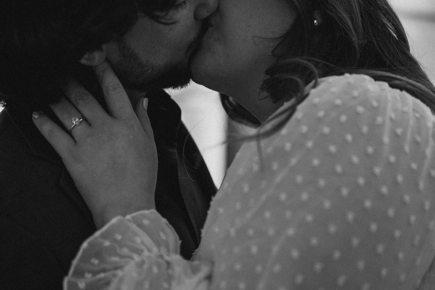 Intimate black and white portrait of couple sharing tender moment.